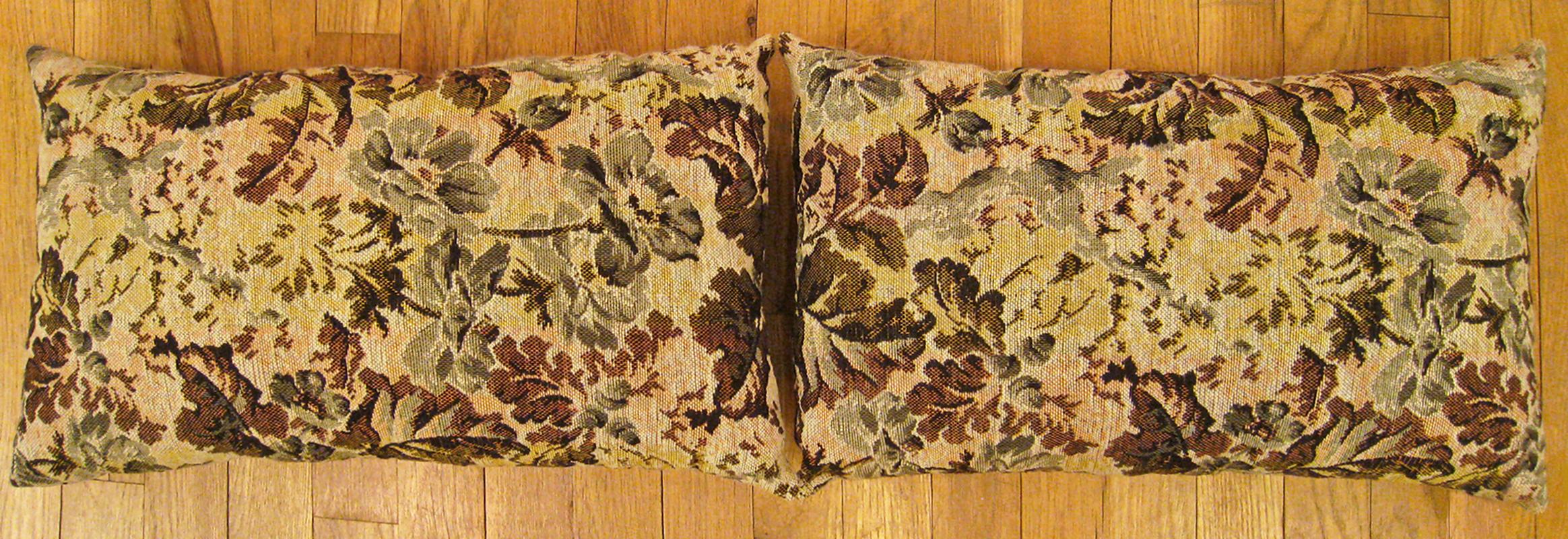 A pair of antique Jacquard Tapestry pillows ; size 1'0” x 1'8” each. 

An antique decorative pillows with floral elements allover a light shrimp central field, size 1'0