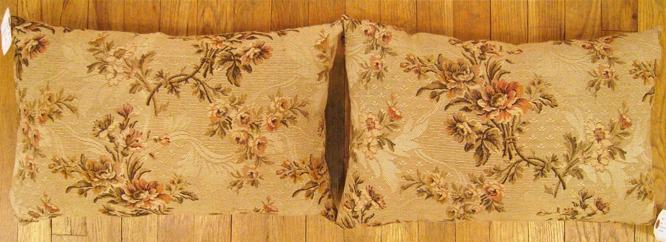 A pair of antique jacquard tapestry pillows ; size 1'2” x 1'9” each.

An antique decorative pillows with floral elements allover a dusty rose central field, size 1'2