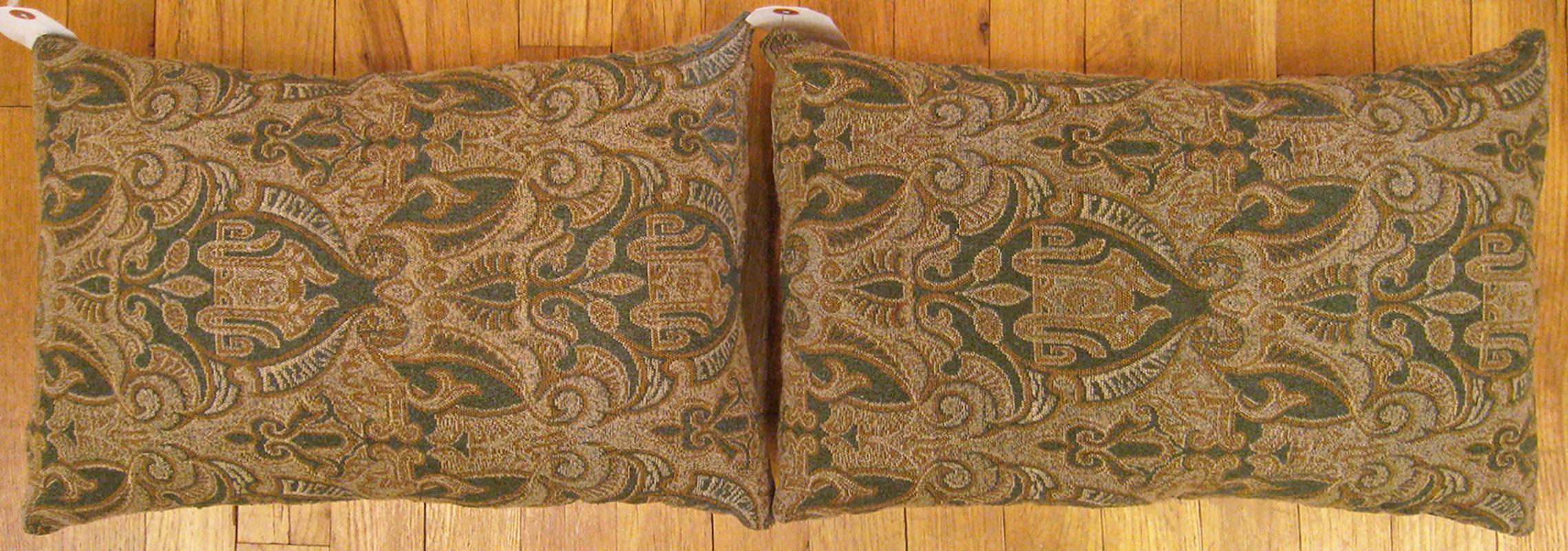 A pair of antique jacquard tapestry pillows ; size 1'0” x 1'7” each. 

An antique decorative pillows with geometric abstracts allover a light brown central field, size 1'0