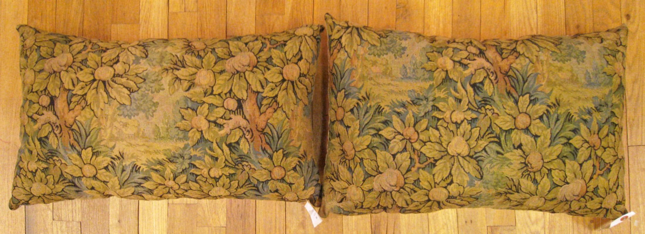 A pair of antique jacquard tapestry pillows; size 1'2” x 2'0” each.

An antique decorative pillows with trees allover a green central field, size 1'2