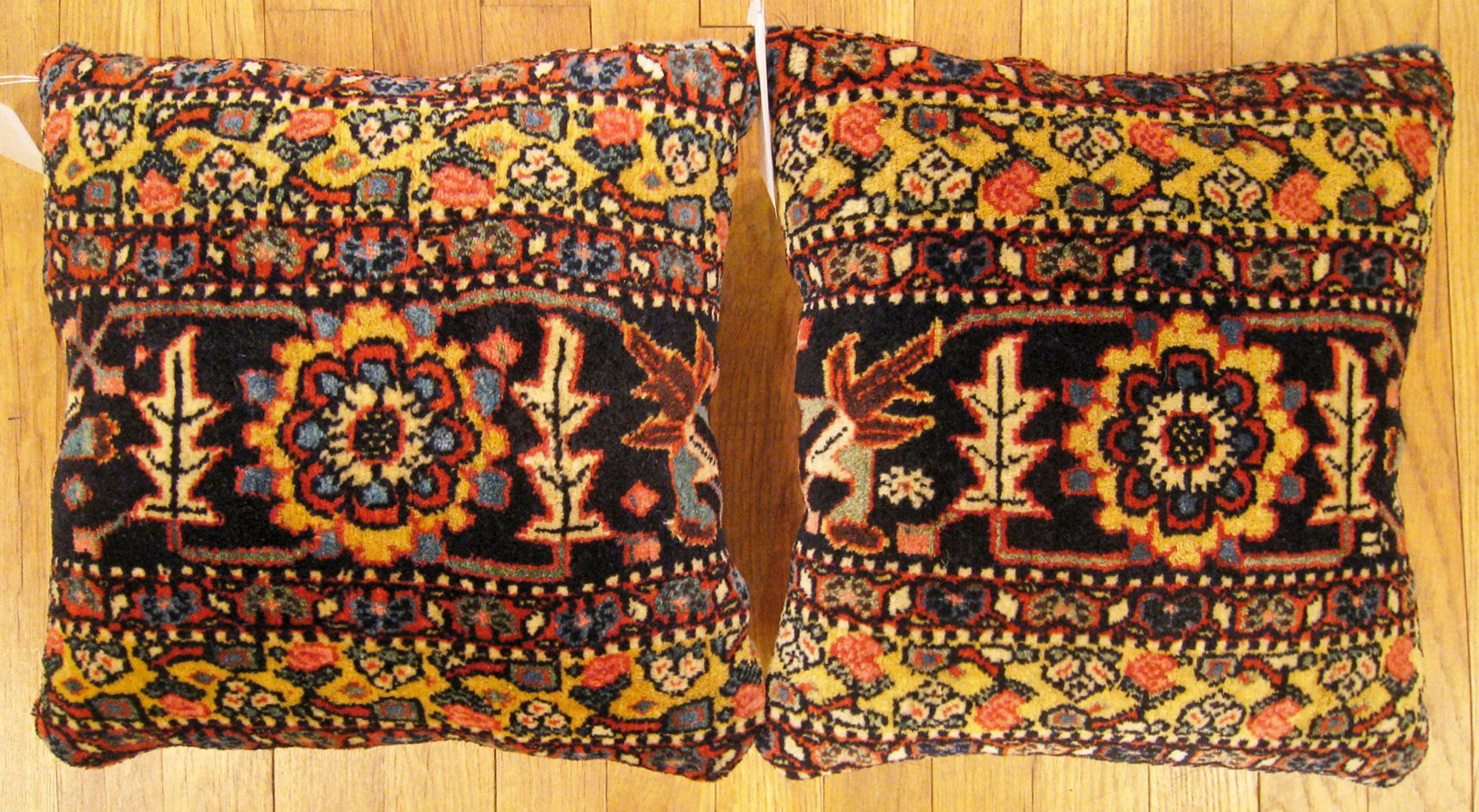 A Pair of Antique Persian Bidjar carpet pillows; size 1'2” x 1'2” Each.

An antique decorative pillows with floral elements in a black central field, size 1'2” x 1'2” each. This lovely decorative pillow features an antique fabric of a Persian Bidjar