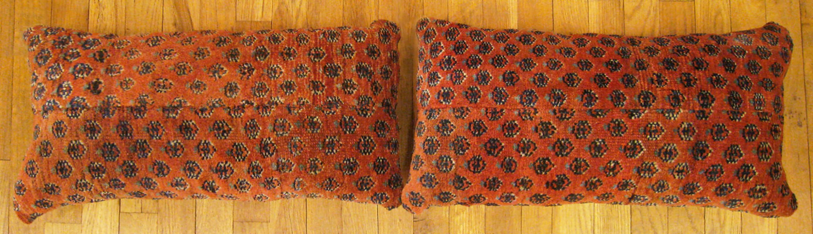A pair of antique Persian saraband carpet pillows ; size 2'0” x 1'2” each.

An antique decorative pillows with floral elements allover a red central field, size 2'0” x 1'2” each. This lovely decorative pillow features an antique fabric of a