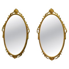 A Pair of Decorative Oval Gilt Wall Mirrors
