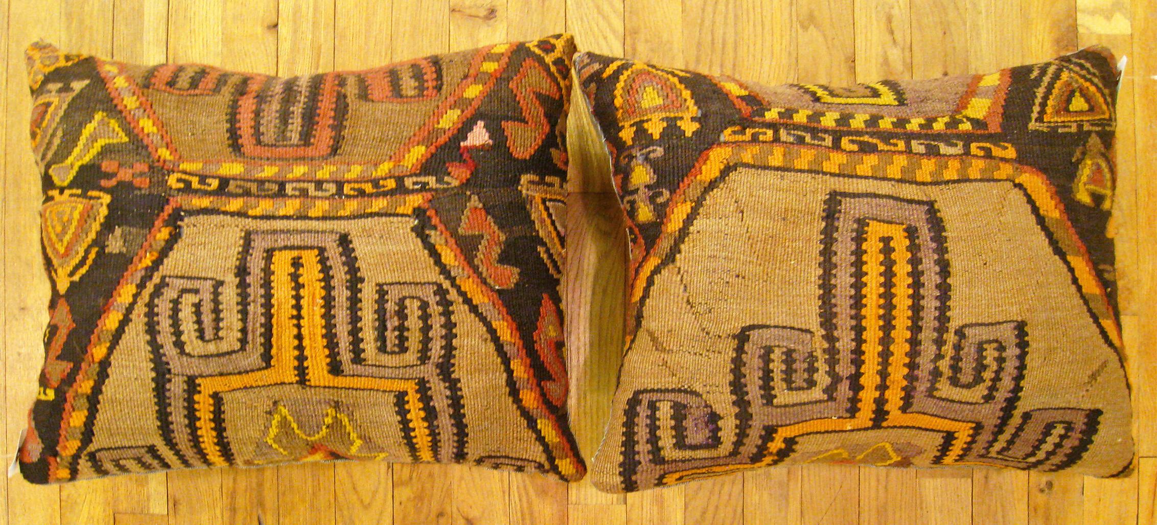 A Pair of Vintage Turkish Kilim rug pillows; size 22” x 18” Each.

A vintage decorative pillows with geometric abstracts allover a brown central field, size 22” x 18” each. This lovely decorative pillow features a vintage fabric of a KIilim carpet