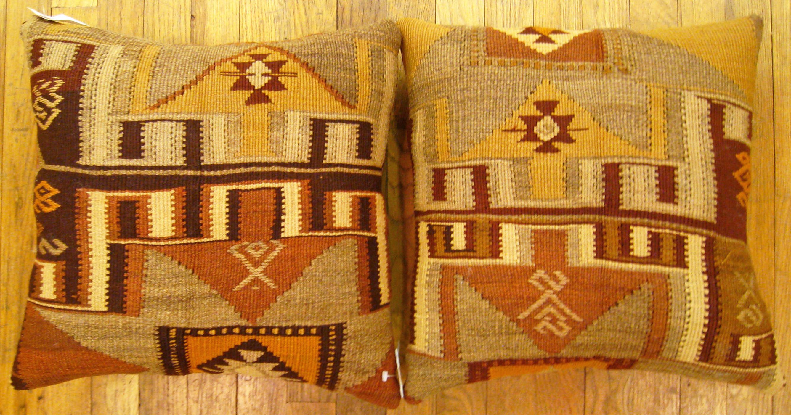 A pair of vintage Turkish Kilim rug pillows; size 18” X 17” each.

A vintage decorative pillows with geometric abstracts allover a brown central field, size 18” X 17” each. This lovely decorative pillow features a vintage fabric of a KIilim carpet