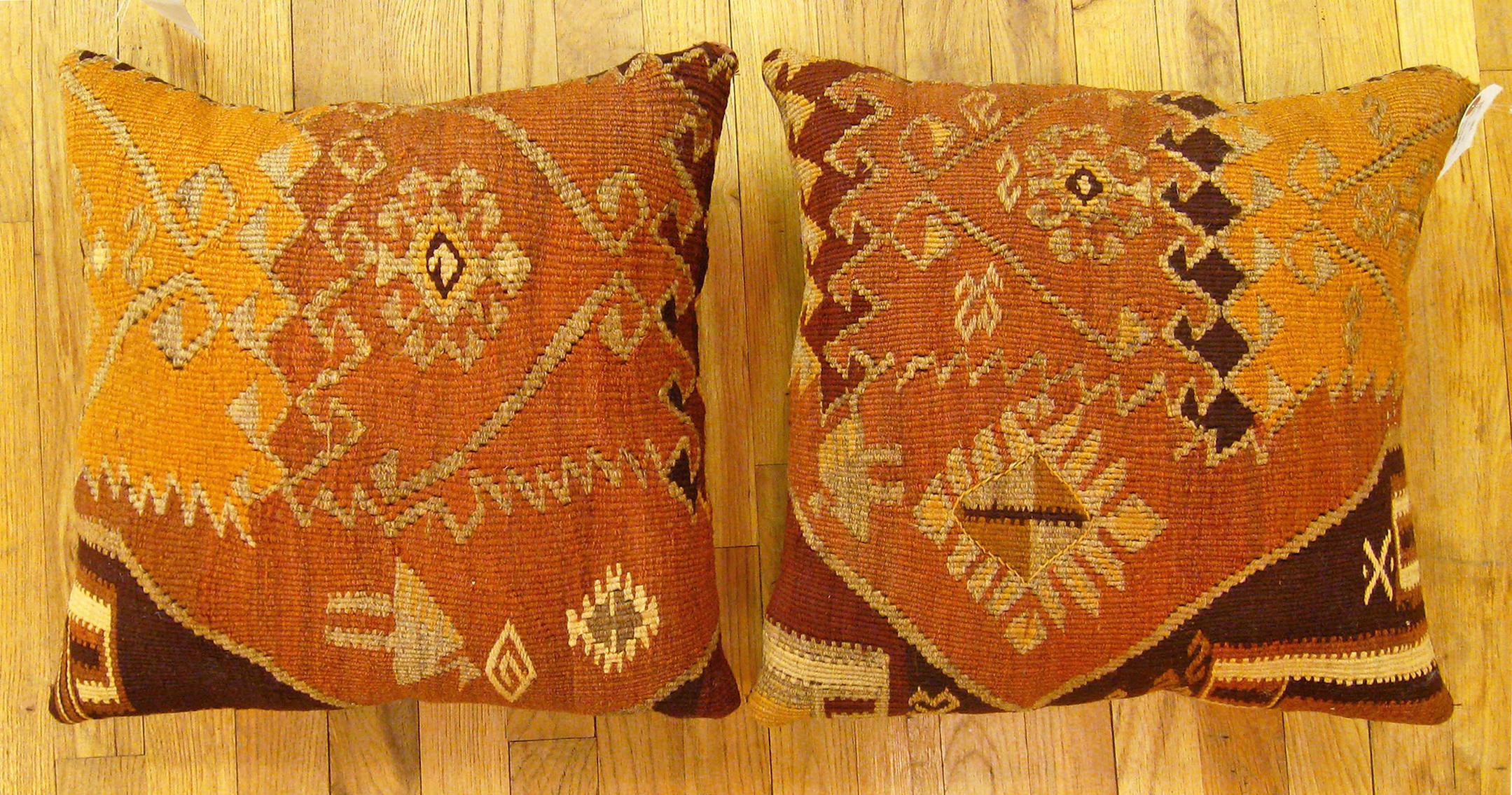 A Pair of Vintage Turkish Kilim rug pillows; size 17” X 17” Each.

A vintage decorative pillows with geometric abstracts allover a brown central field, size 17” X 17” each. This lovely decorative pillow features a vintage fabric of a KIilim carpet