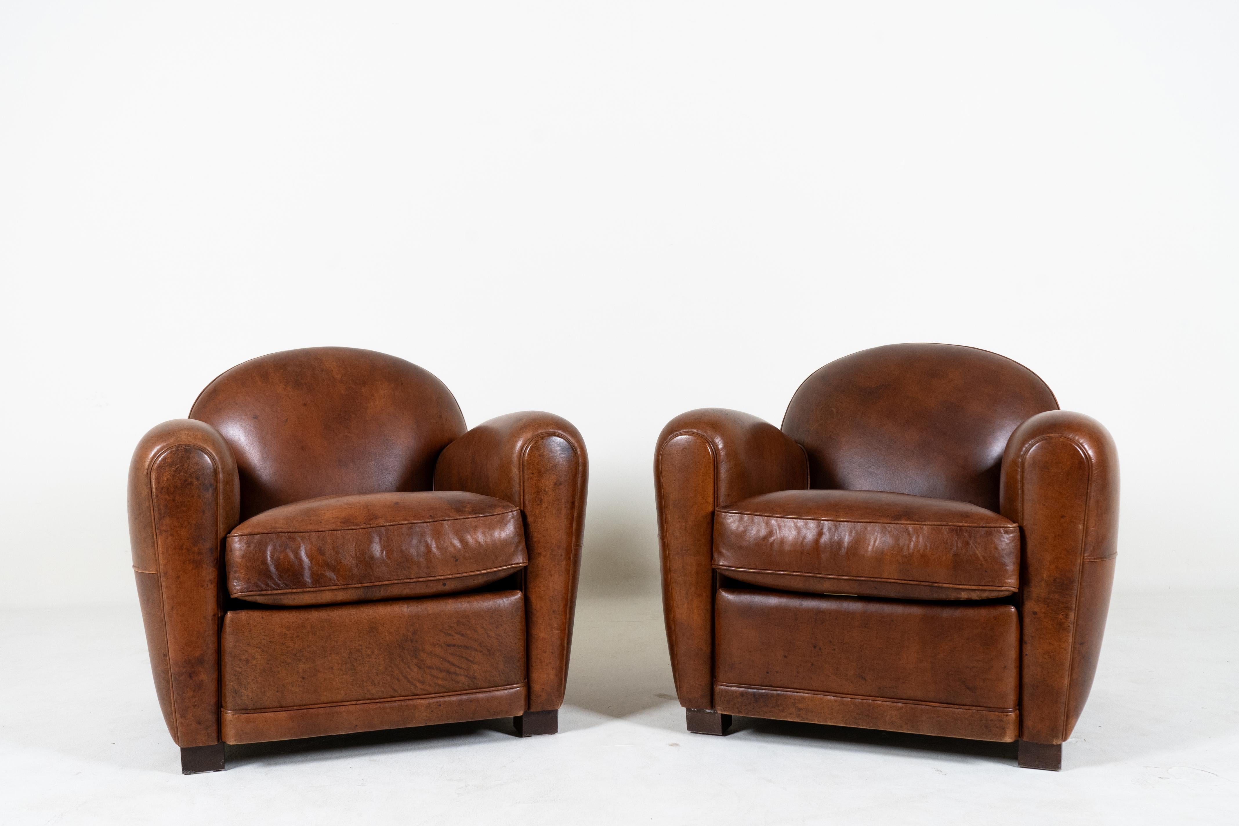 A Pair of Demi Lune French Club Chairs in Patinated Leather In Good Condition For Sale In Chicago, IL