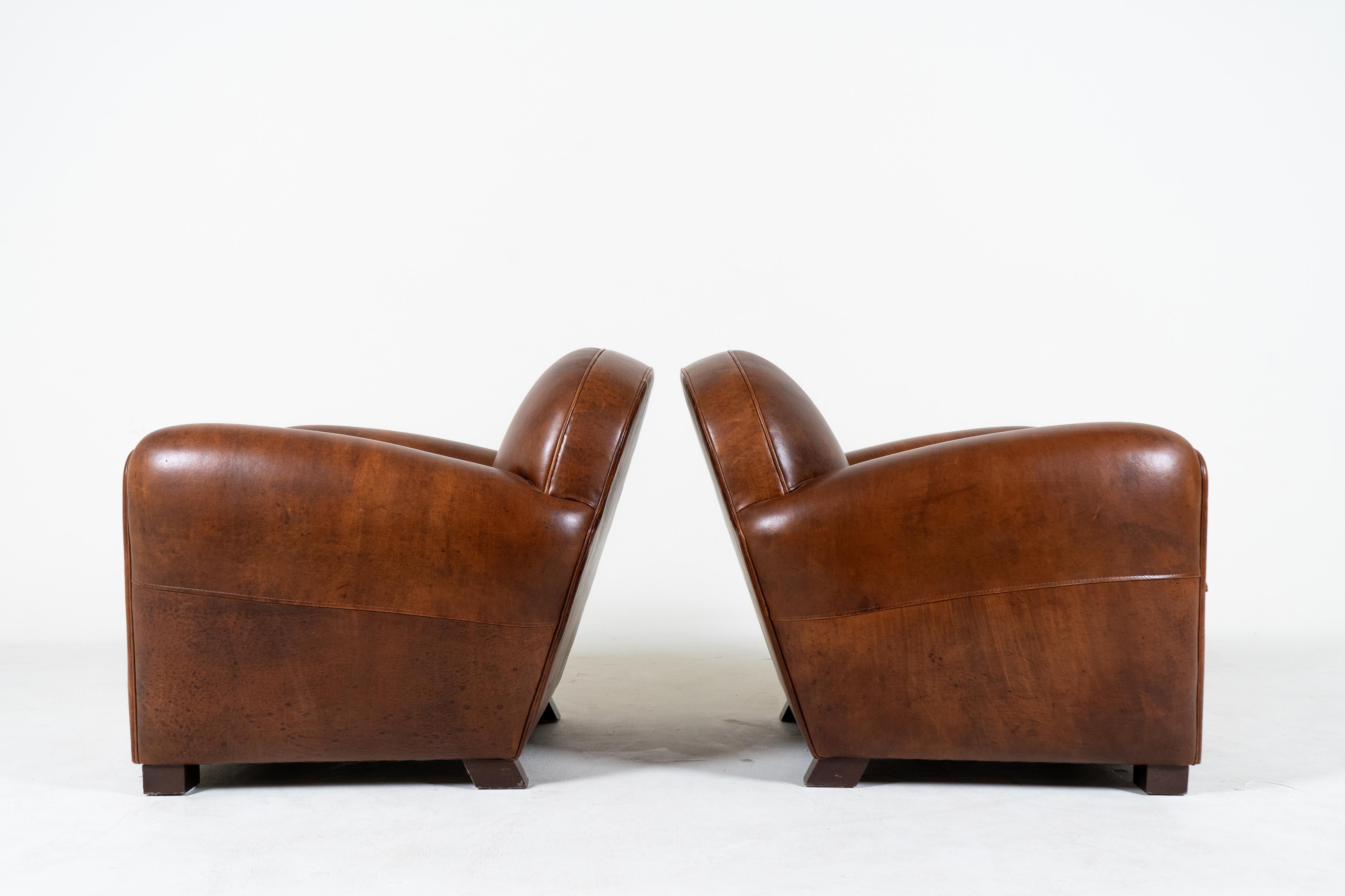 A Pair of Demi Lune French Club Chairs in Patinated Leather For Sale 1