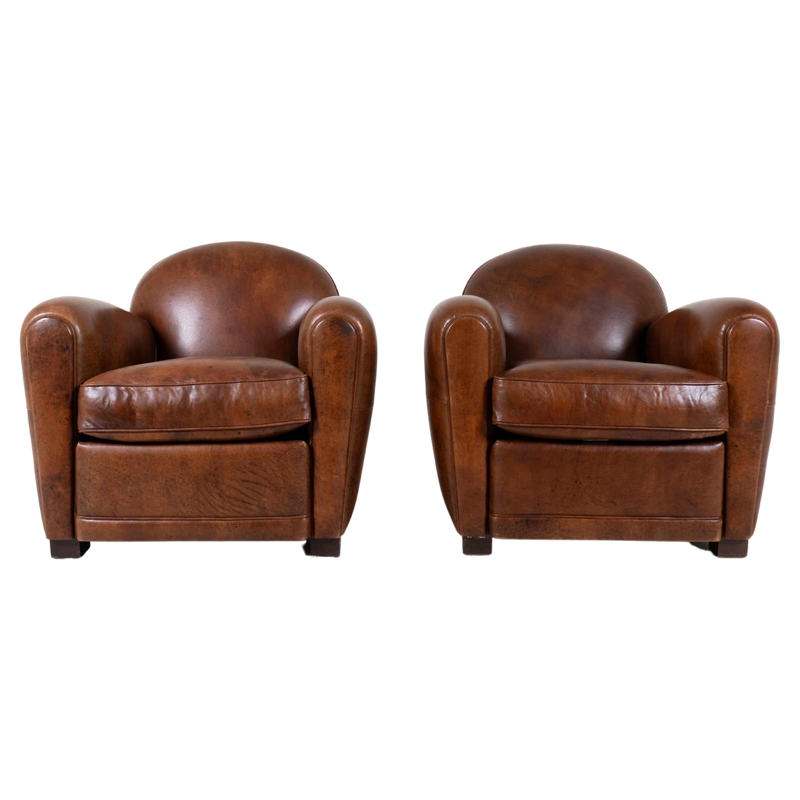 A Pair of Demi Lune French Club Chairs in Patinated Leather For Sale