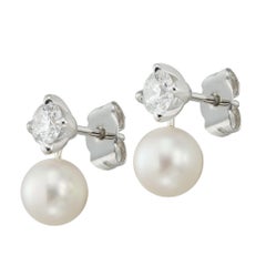 A pair of diamond and cultured pearl earrings