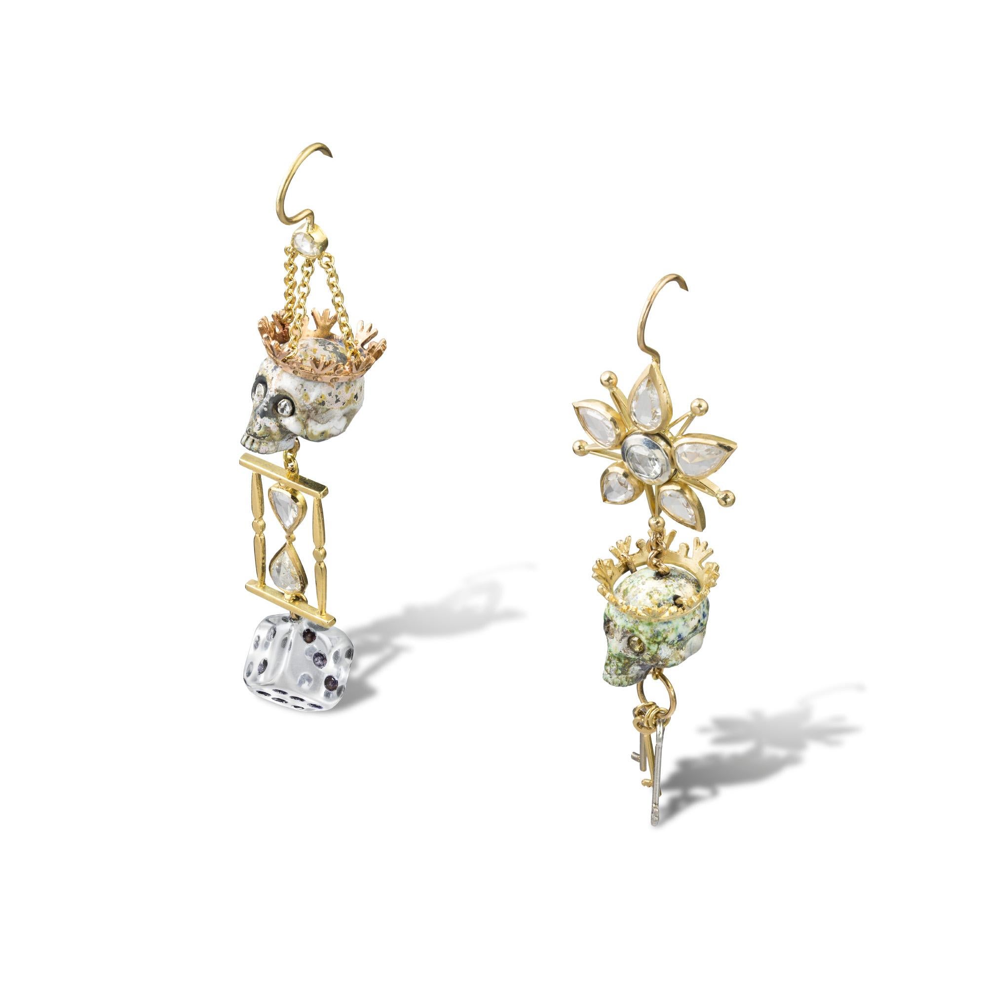 A pair of diamond and enamel skull earrings, the first earring set with a floral top of five pear shape diamonds suspending a crowned enamel skull in patchy green and white enamel with diamond-set eyes leading to three keys graduated in size in