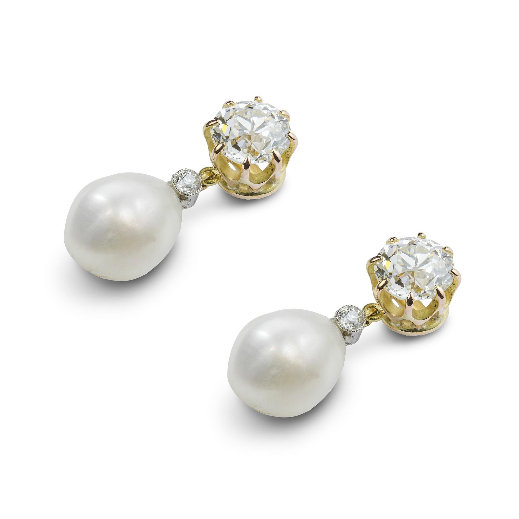 A pair of natural pearl and diamond drop earrings, the two pear shape pearls accompanied by GCS report stating the pearls to be natural and of saltwater origin, each surmounted by a millegrain-set diamond, all suspended from a larger old