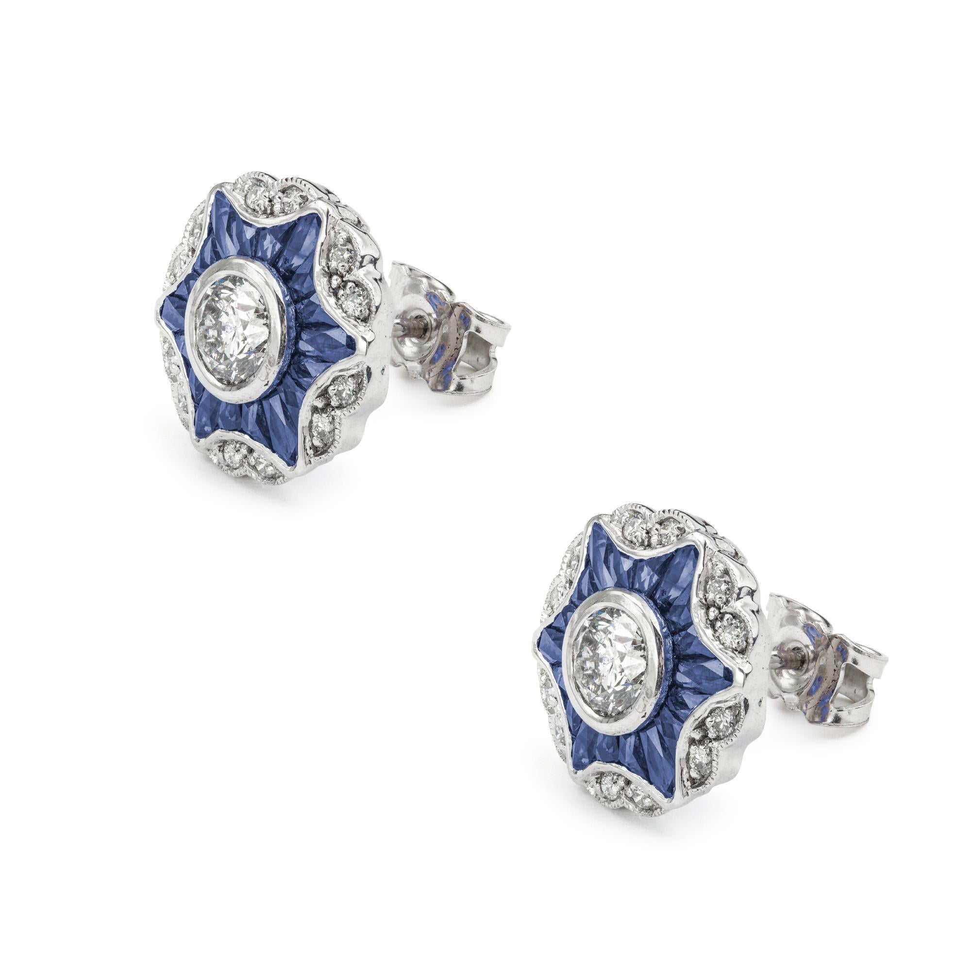 A pair of diamond and sapphire cluster star earrings, the round brilliant-cut diamond centre, weighing 1.19 carats in total, surrounded by eighteen calibre-cut sapphires in the form of a star and an outer cluster of twelve brilliant-cut diamonds,