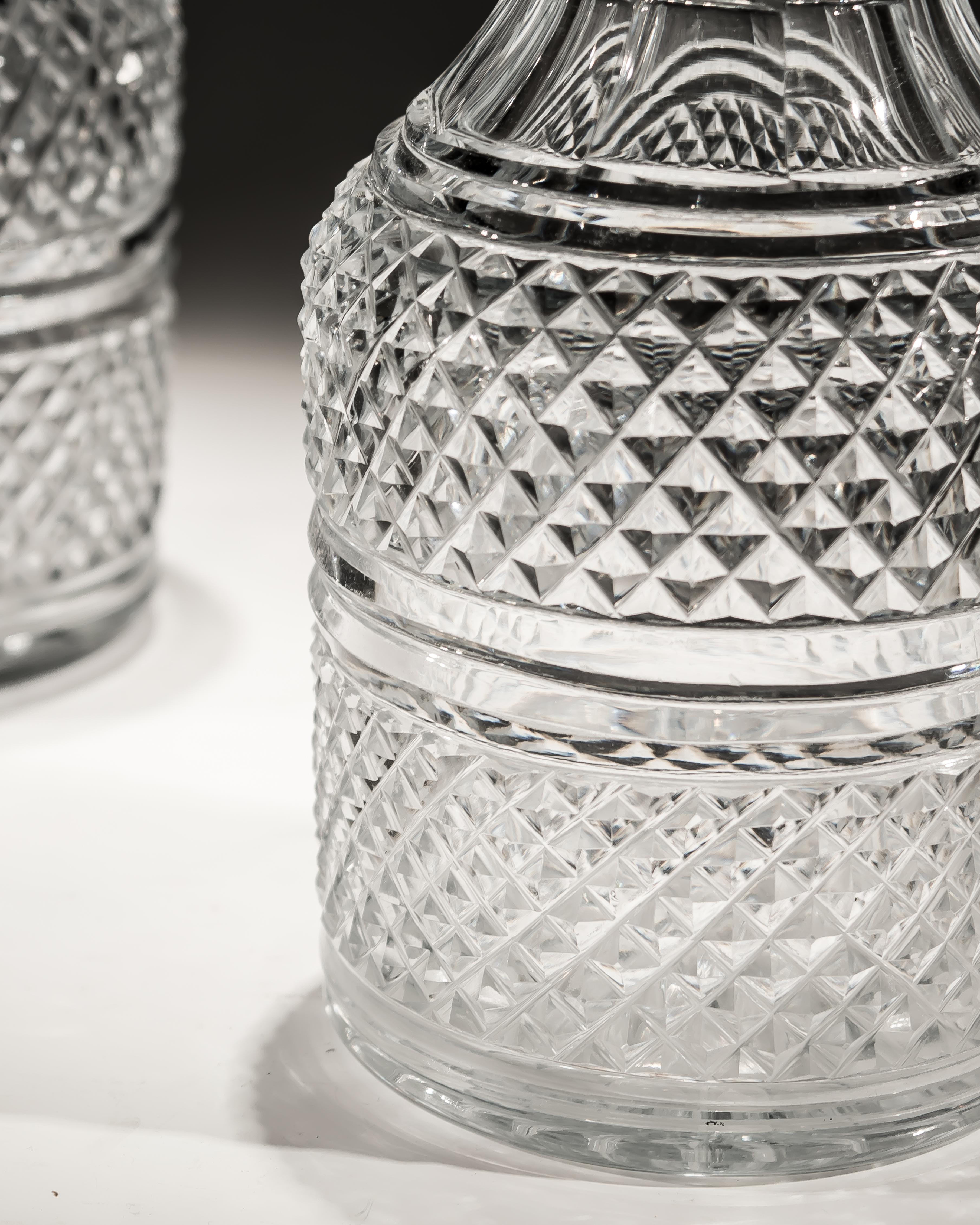 A pair of diamond cut regency decanters.