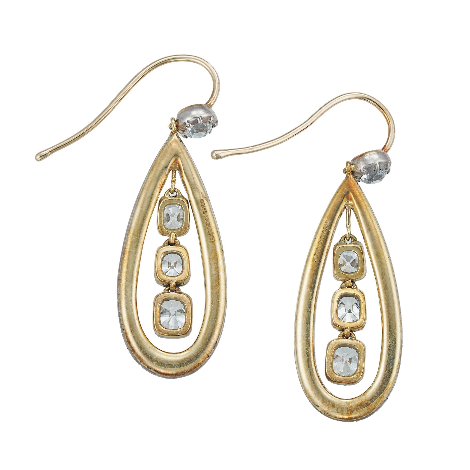 A pair of diamond drop earrings, each earring with three old-cut diamonds suspended within a pear-shape diamond frame all beneath an old-cut diamond surmount, the top and three suspended old-cuts weighing a total of 3.3cts and the surrounding