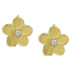 A pair of diamond-set yellow gold flower earrings