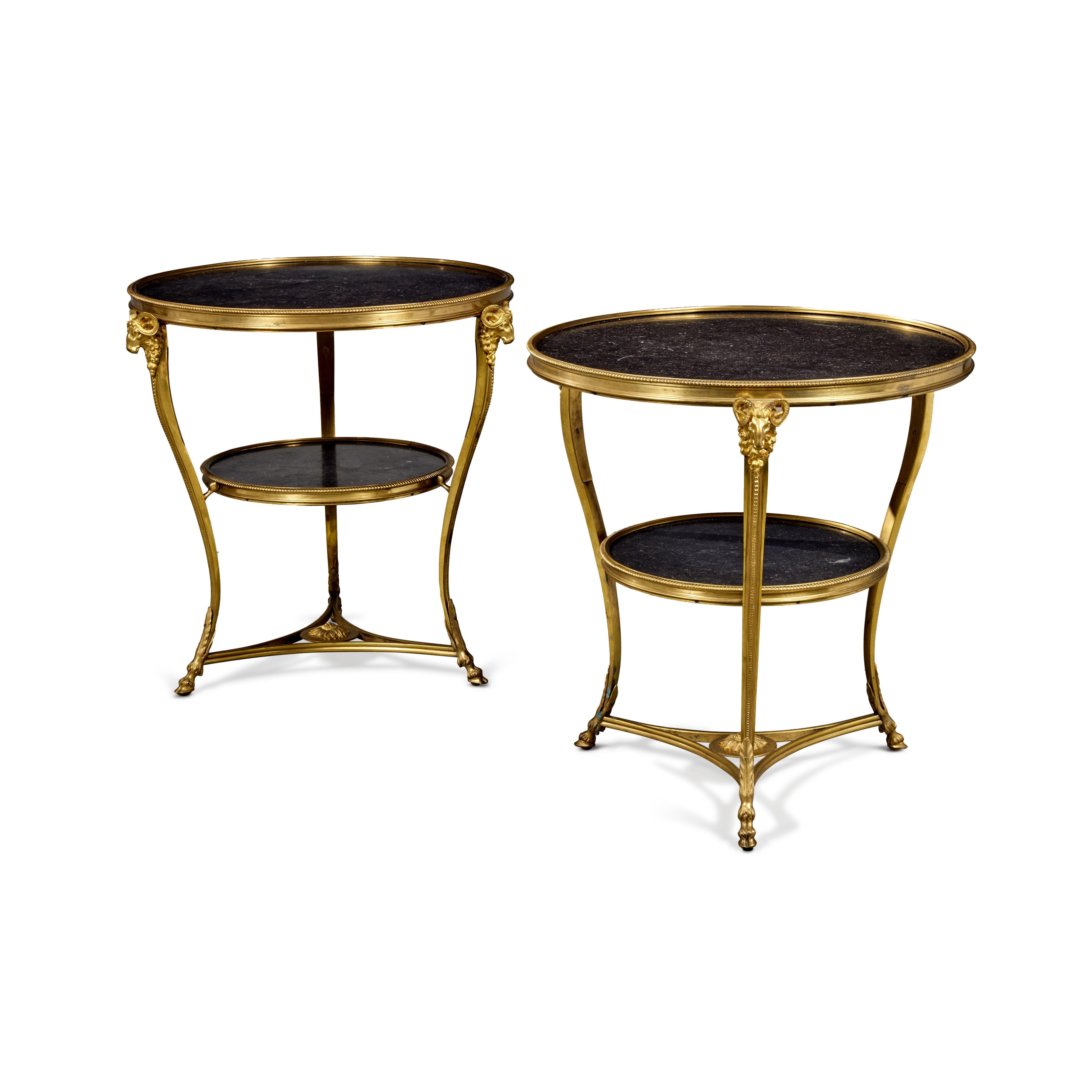 A Pair of 1890-1900 Directoire Style Gilt Bronze and Black Marble Gueridons. Each with very fine ormolu mounts as well as hand-carved marble tops. Exceptional details on the ormolu including three ram's heads on either side of the legs. This is