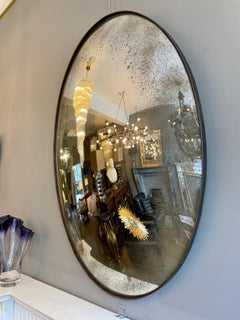 A Pair Of Distressed Silver Oval Convex Mirrors