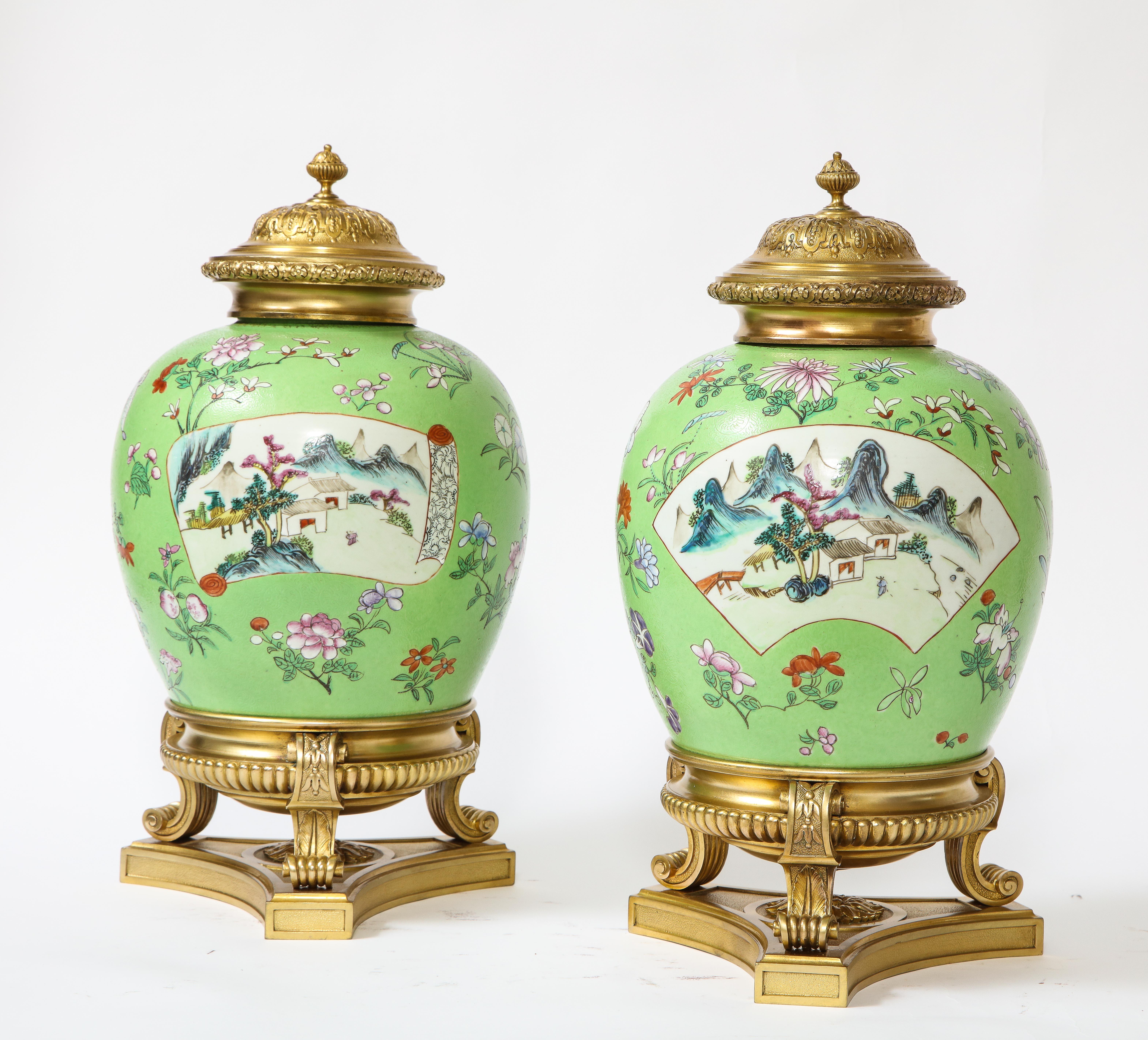 A fabulous and quite beautiful pair of Louis XVI style dore bronze mounted Chinese Famille Rose porcelain, sgraffito ground covered vases or por pourries. Each is exceptionally hand painted with an array of beautiful enamels on a vert sgraffito