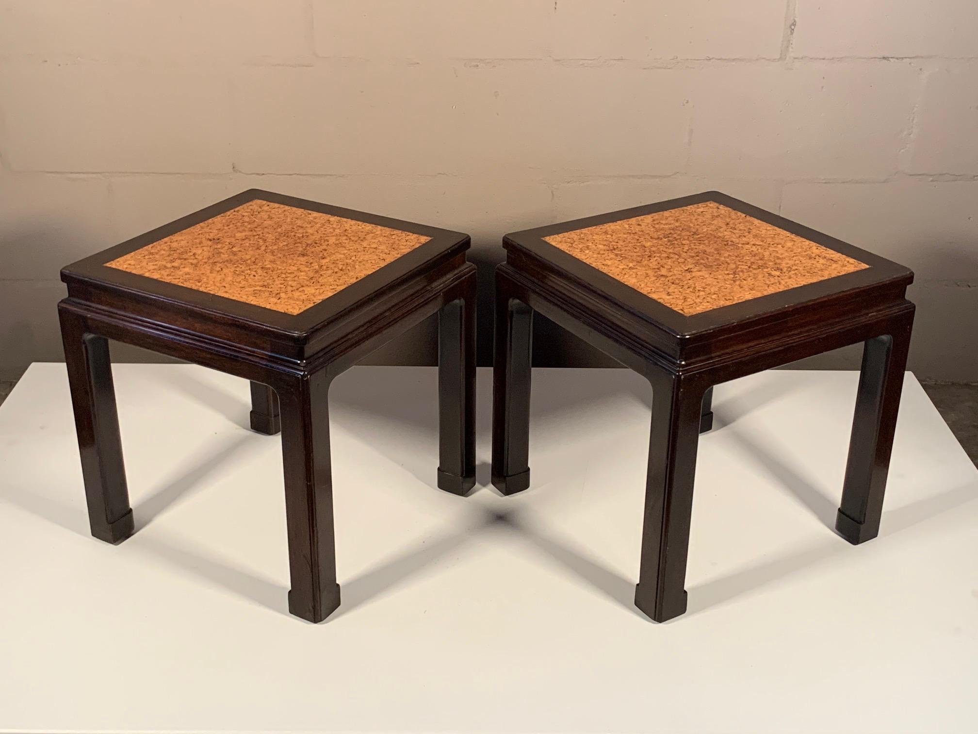 An unusual and rare pair of side tables by Edward Wormley for Dunbar, circa 1940s. Mahogany with original cork tops, Asian Style with green Dunbar labels.