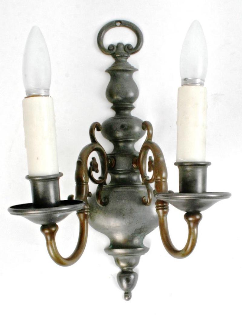 A pair of Dutch, brass and pewter double light wall sconces, early 20th century. Both are electrified and will hold a standard bulb. The contrast between the pewter and the brass is beautiful. They each measures 14.75
