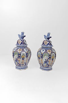 A Pair of Dutch Delft Covered Vases with Foo Dog Finials