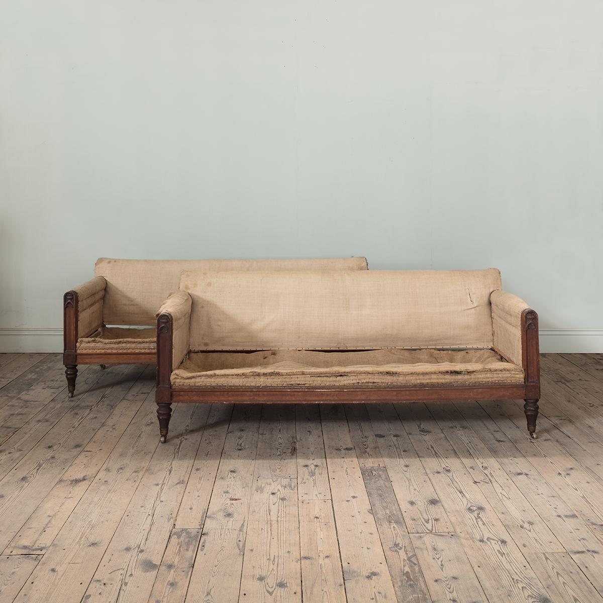 A Pair of Early 19th Century Carved Oak Sofas, Designed by William Atkinson

With subtly carved gothic detailing to the arm, and low, broad and deep dimensions. From the workshops of William Atkinson, an English architect most highly regarded for