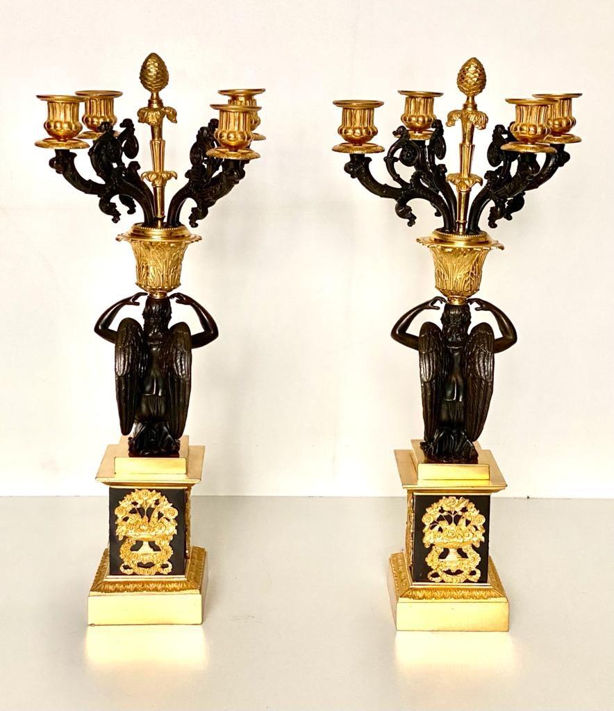 A fine quality pair of 19th century French Empire bronze Dor'e four-light candelabra
In the manner of Pierre-Philippe Thomire, 
Similar to a pair that can be found in the Metropolitan Museum of Art in New York.
Each cast with a winged figure