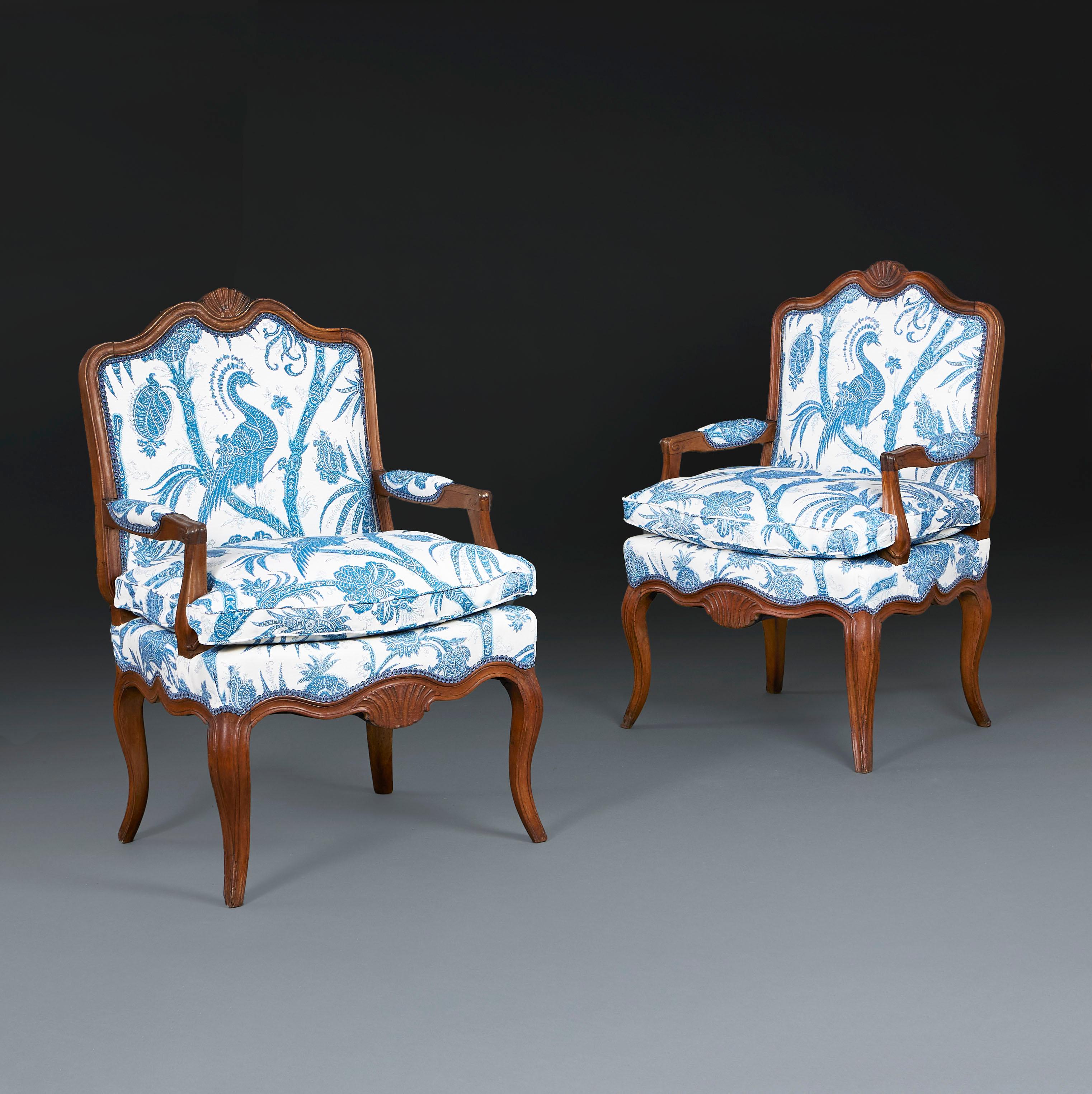 France, circa 1820

A pair of early nineteenth century walnut open armchairs with carved shells to the back seat rail, upholstered seats, all supported on four cabriole legs.

Upholstered in a blue and white Bennison fabric.

Height 98.50cm
Width
