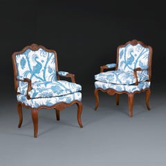 A pair of Early 19th Century French Walnut open Armchairs