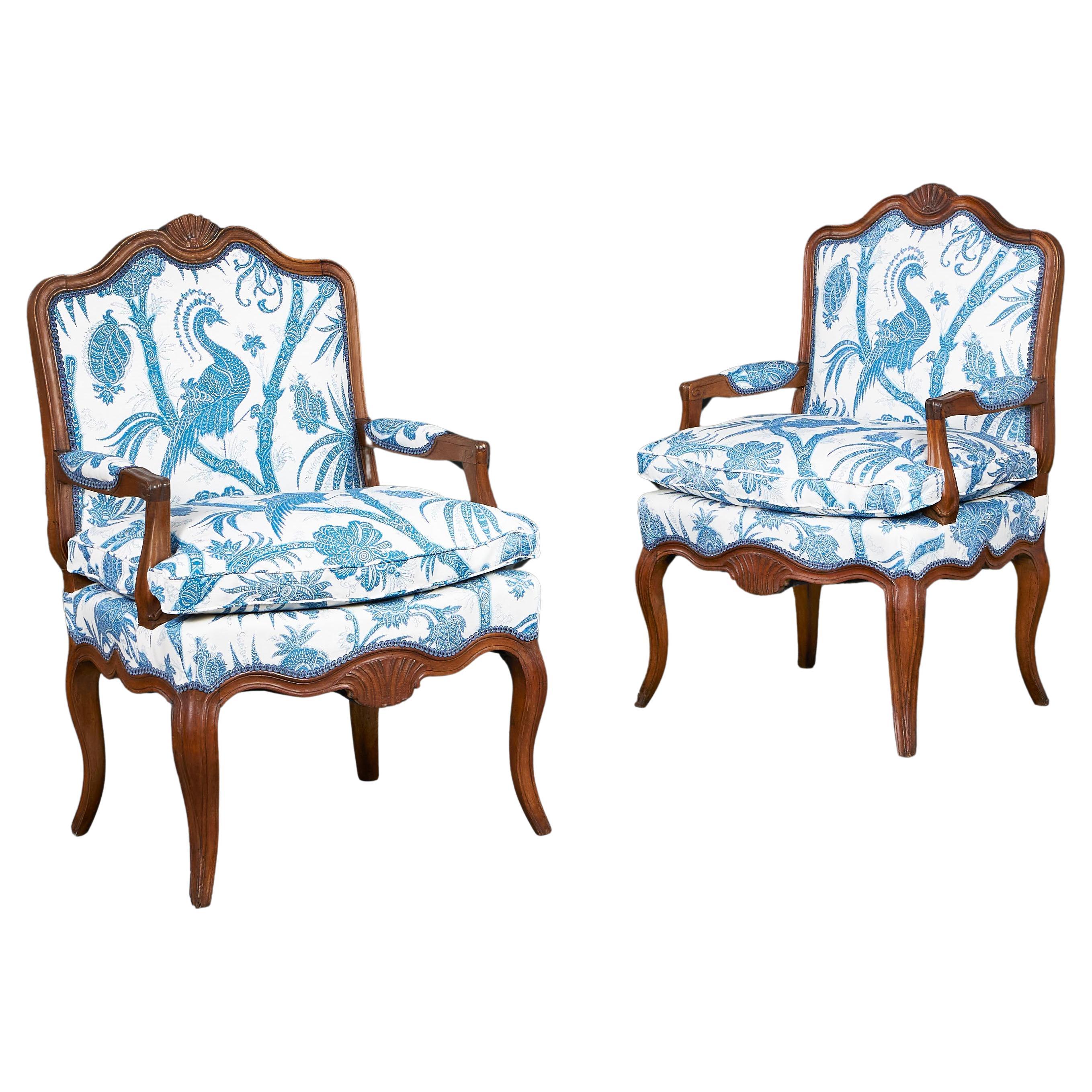 A pair of Early 19th Century French Walnut open Armchairs 