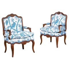 A pair of Early 19th Century French Walnut open Armchairs 