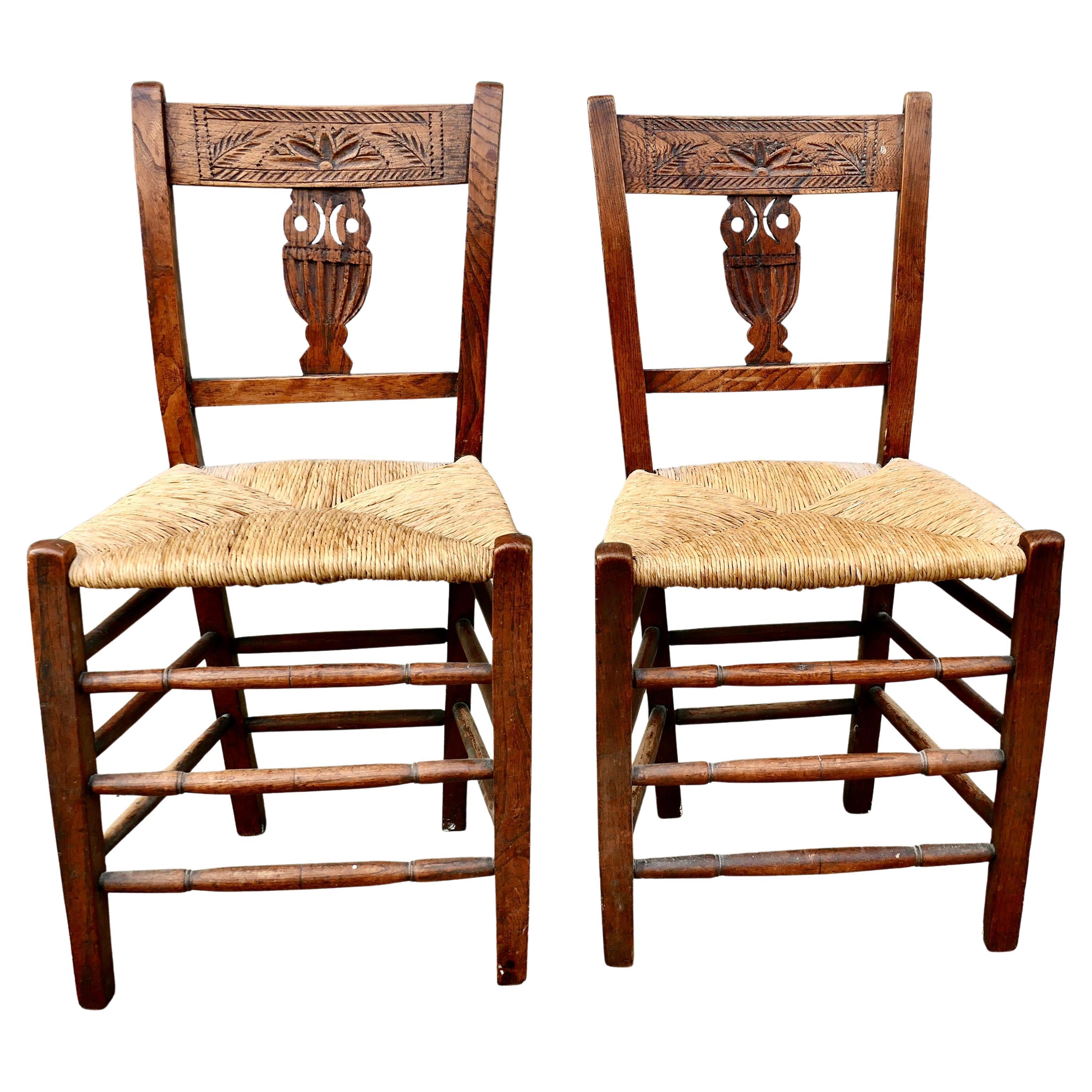 A Pair of Early 19th Century Rush Seated Elm Hall Chairs