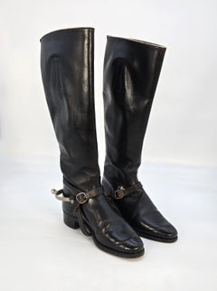 A pair of early 20th century leather riding boots with accessories