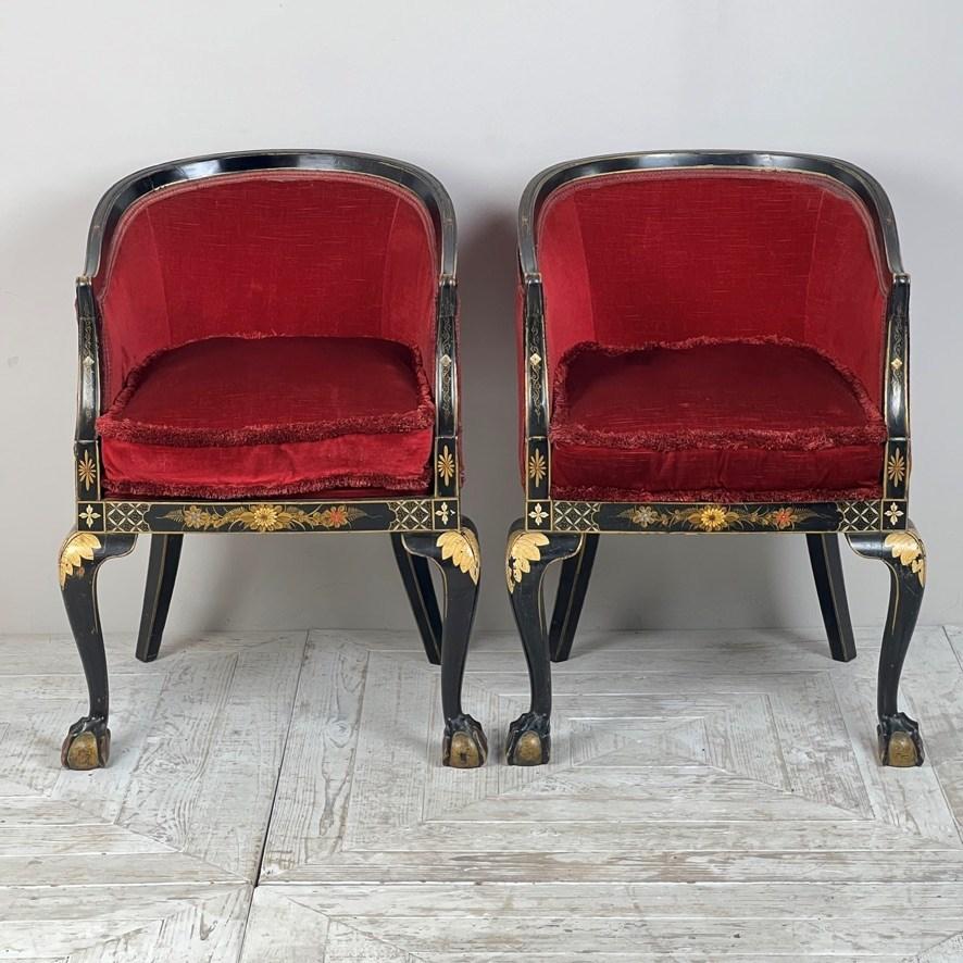 Enhance your living space with this elegant set of Early 20th Century Japanned Tub Chairs, inspired by the Georgian style. The ebonised frame features tasteful gilded accents, complemented by gilded cariole legs with intricately carved 'claw and