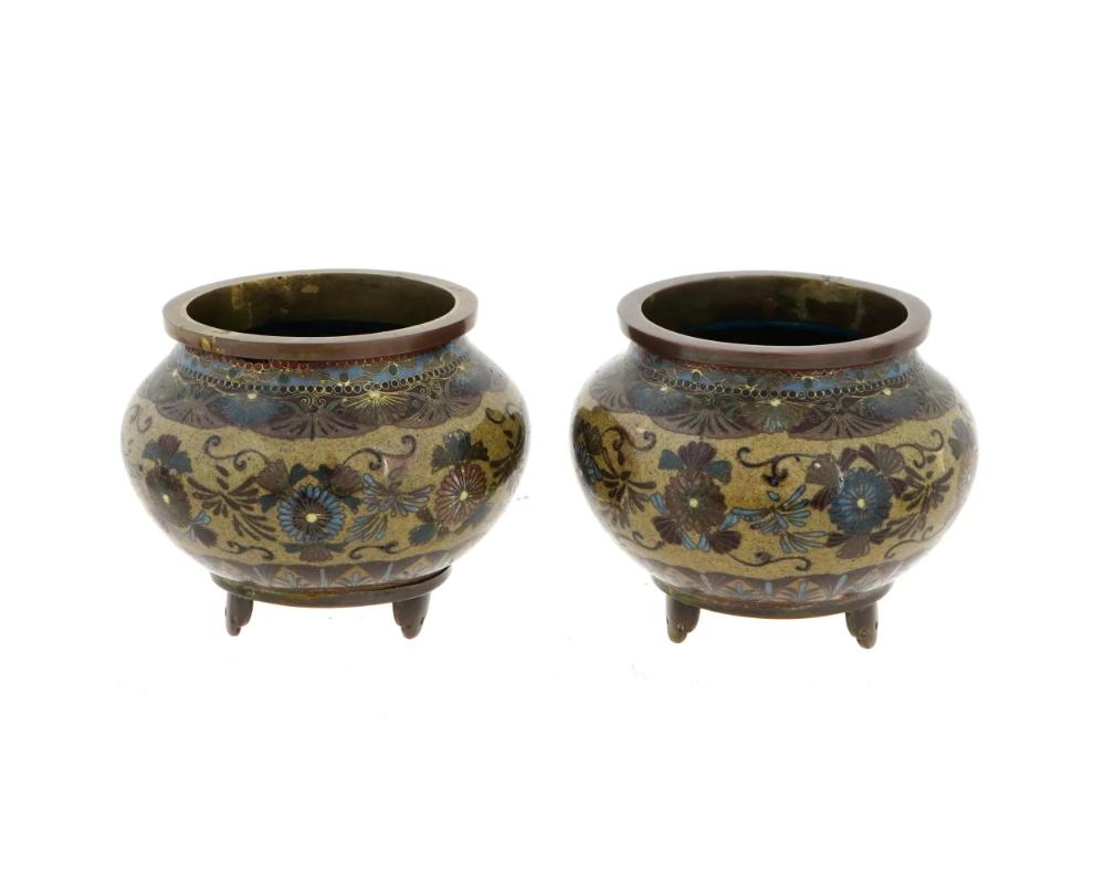 A pair of high quality Japanese early Meiji period bronze and cloisonne enamel planter pots or koro incense burners, each of a globular form with a short flared neck, the exterior is decorated with stylized cloisonne enamel floral patterns and