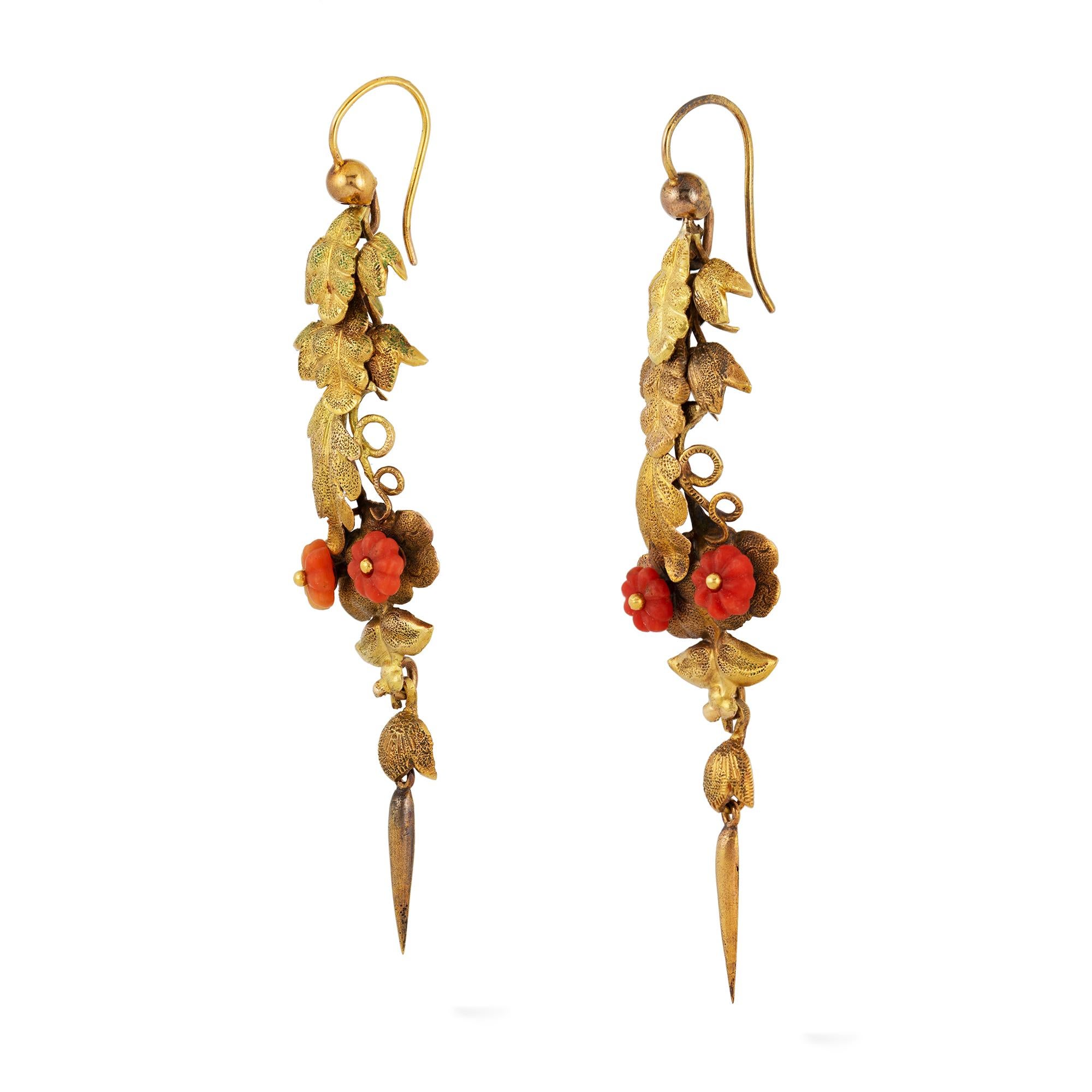A pair of early Victorian gold and coral leaf drop earrings, each earrings with gold foliate and tendril decorations, flanked with two carved coral flowerheads, mounted in gold, circa 1830, measuring approximately 5.9 x 1.3cm, gross weight 4.1