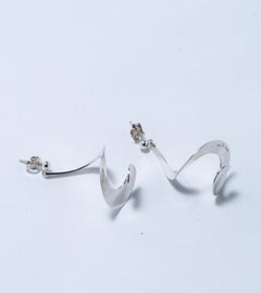 A pair of earrings. "Mobius",  designed by Vivianna Torun for Georg Jensen. 
