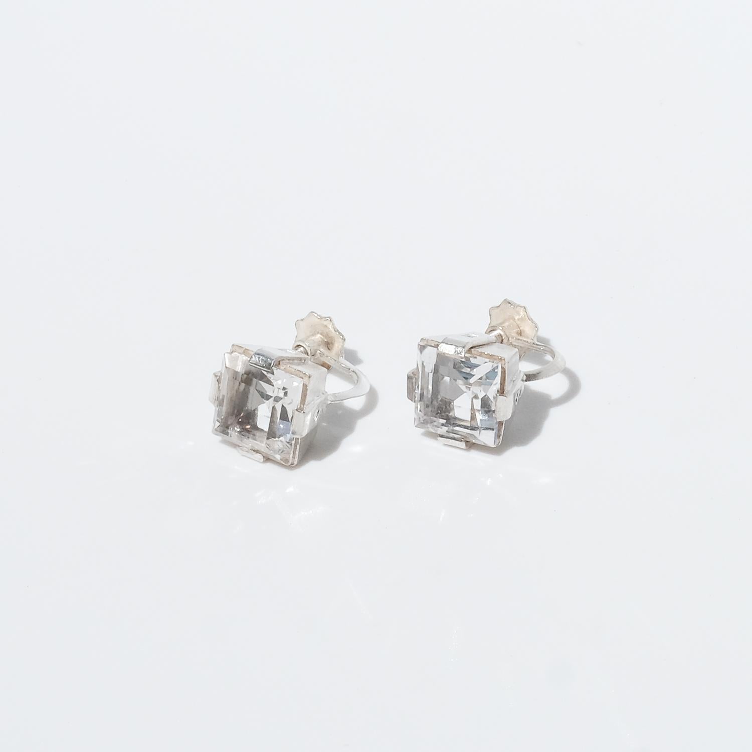 These silver and carré cut rock crystal earrings have a feminine and classic shape. The earrings have so called screw backs, like many of the earrings during the early 1900s through the 1950s had.

The best way to describe what these earrings convey