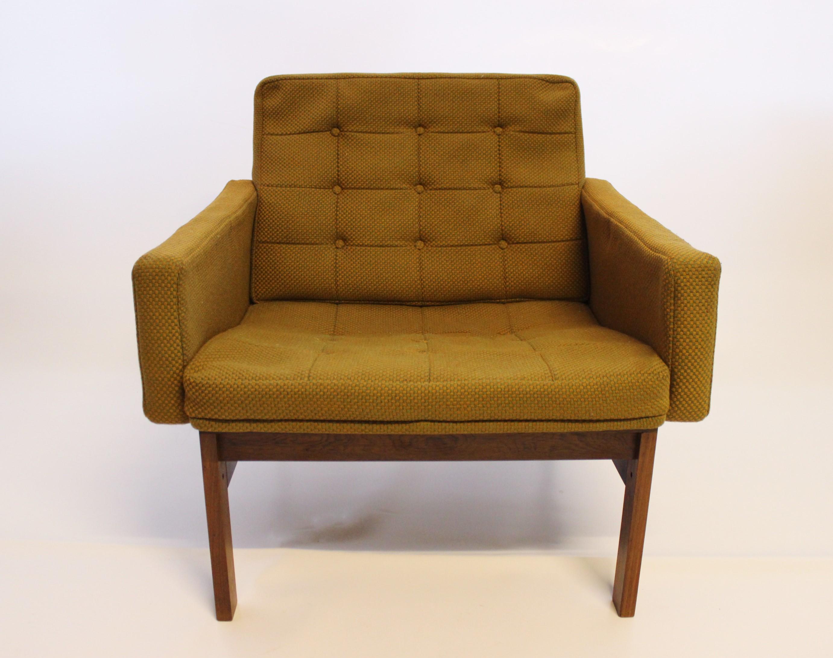 A pair of easy chairs upholstered in dark green fabric and with frame of rosewood designed by Ole Gjerlov Knudsen and Torben Lind, manufactured by France and Son. The chairs are in great vintage condition and from the 1960s.

This product will be