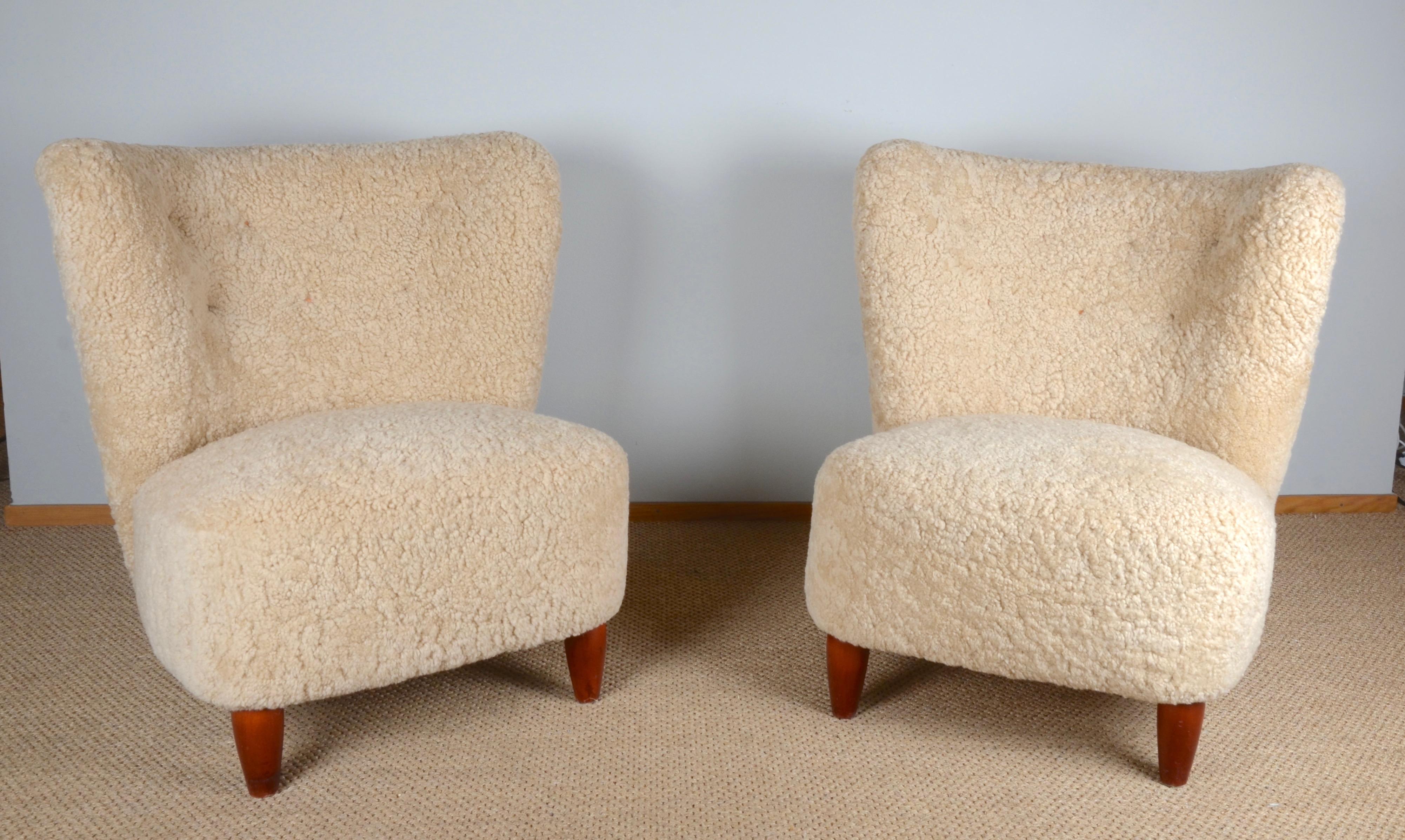 A pair of easy chairs reupholstered in sheepskin. Sweden, 1930/40s.