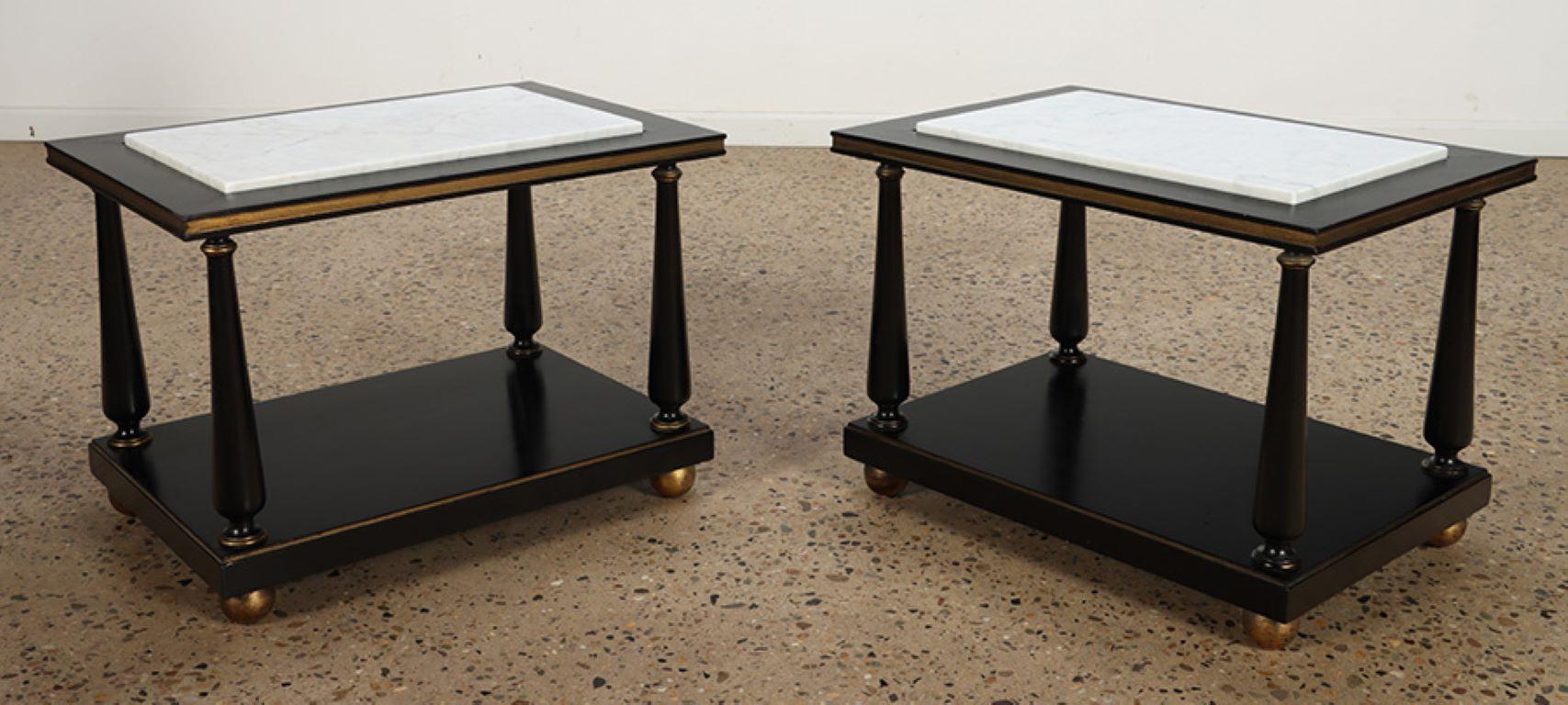 A pair of ebonized and gilt marble top end tables on ball feet circa 1950. In Good Condition For Sale In Philadelphia, PA