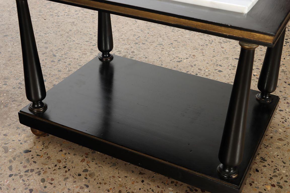 Mid-20th Century A pair of ebonized and gilt marble top end tables on ball feet circa 1950. For Sale