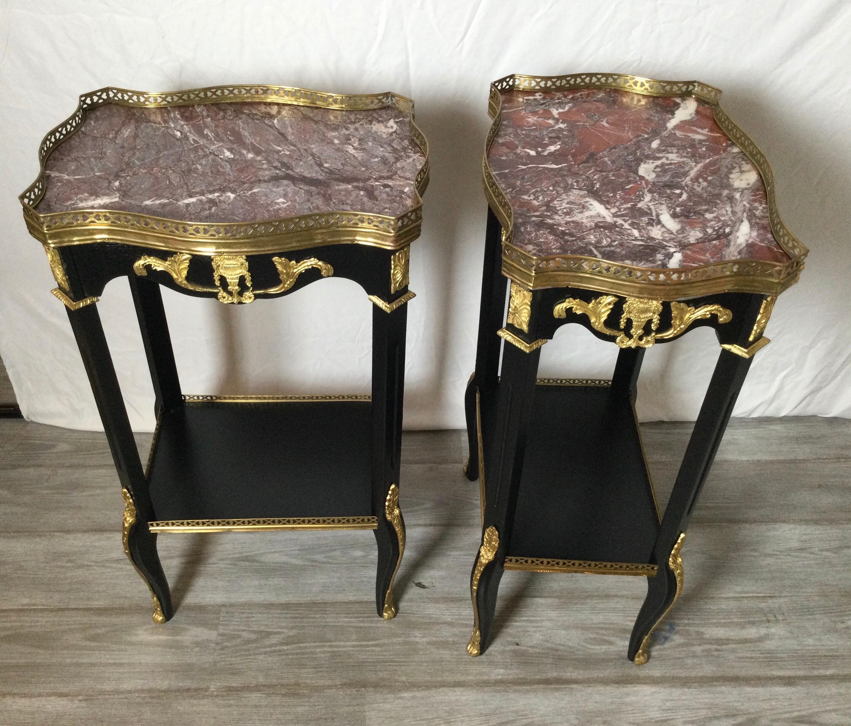 A pair of Louis XV style gallery edge and marble topped side tables with drawer. The ebonized wood with ormolu mounts with a single drawer on the shorter side. These tables can be used in either direction as they are finished on all sides. The