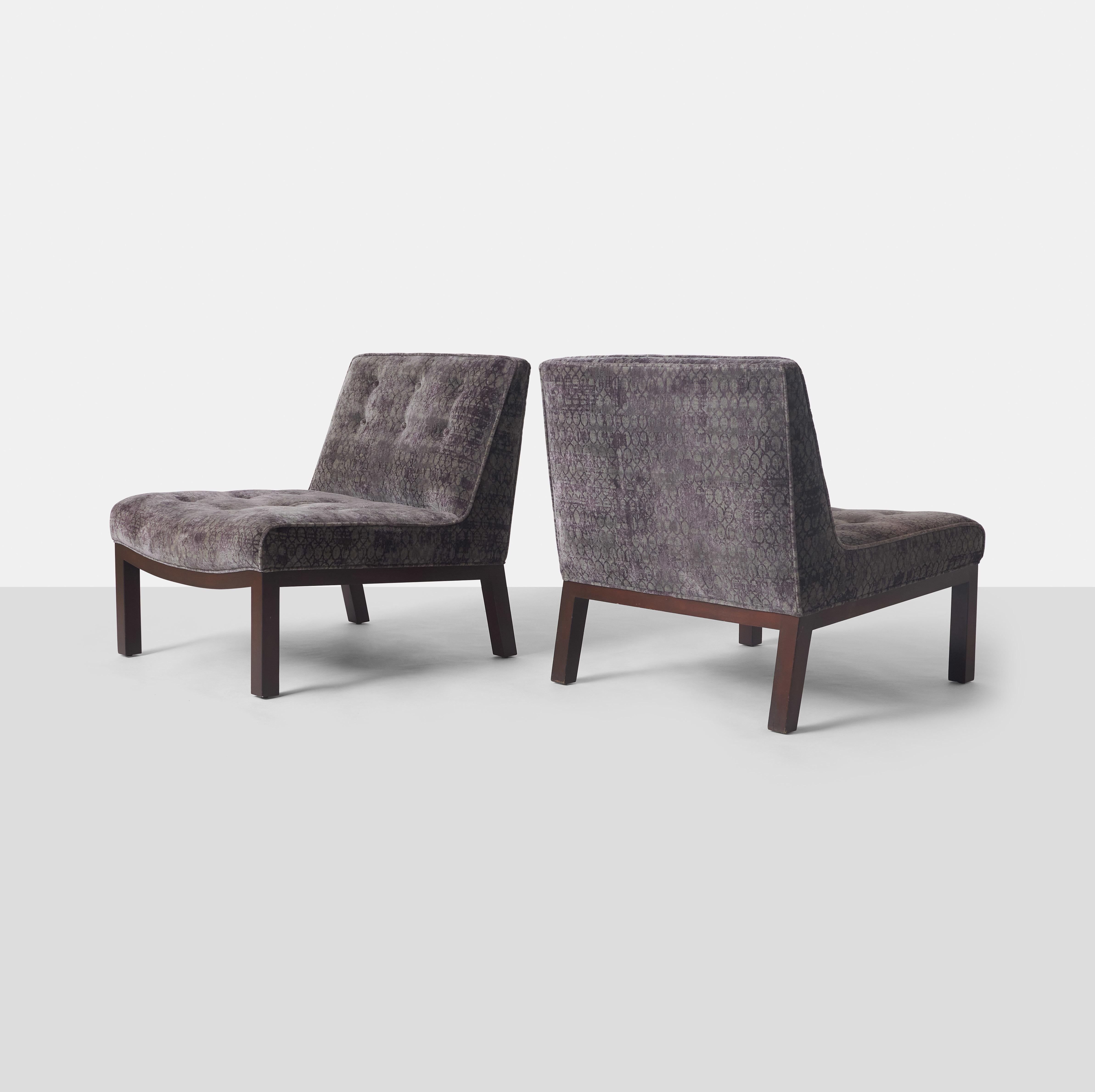 A pair of slipper chairs by Edward Wormley for Dunbar with mahogany feet and covered in the original Jack Lenor Larsen fabric.