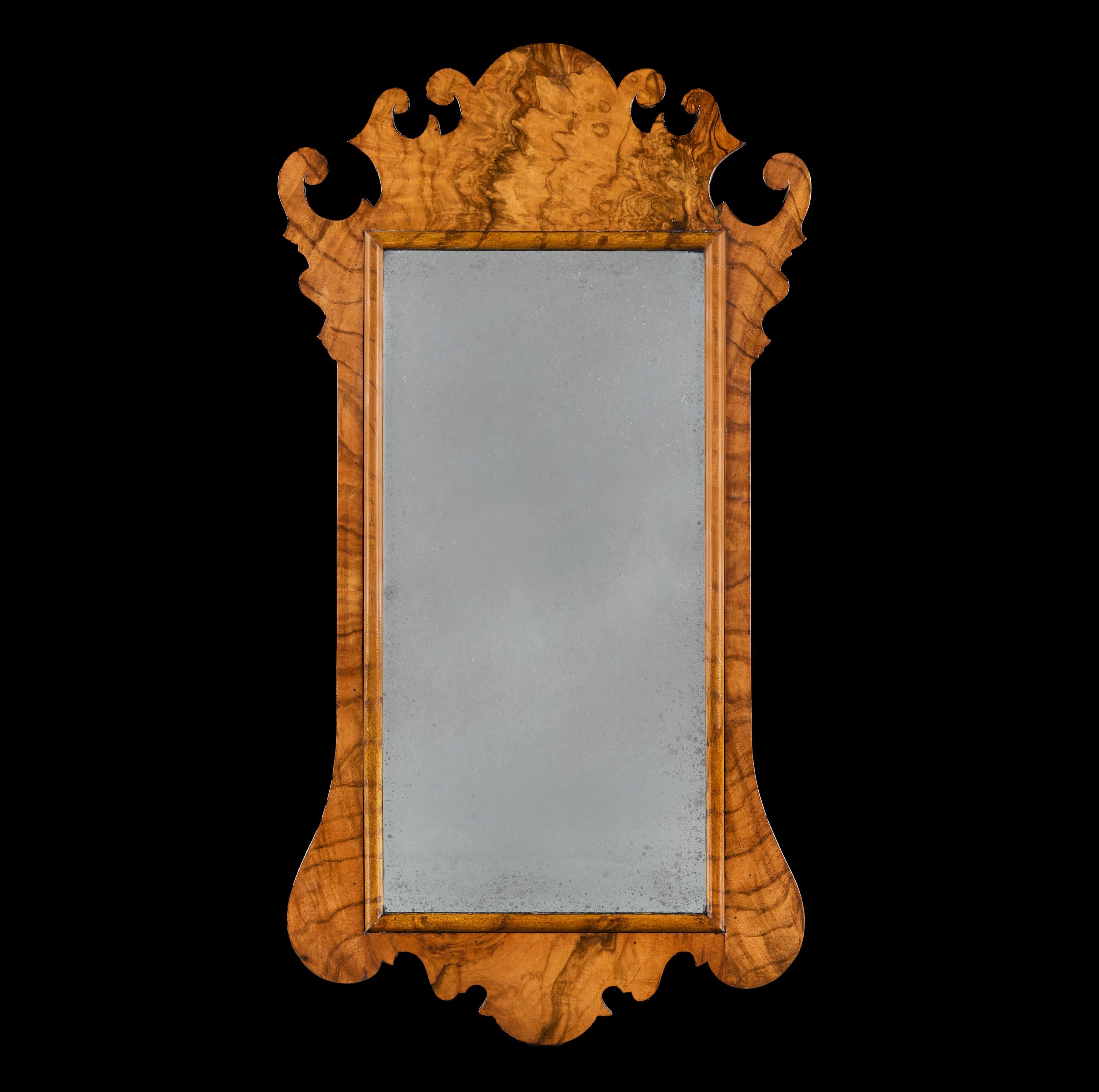England, circa 1910

A pair of early twentieth century fretwork pier mirrors, the frames with carved scrolls to the cresting in a finely figured burr walnut, with oxidised mirror plates.

Height 74.00cm

Width 39.00cm