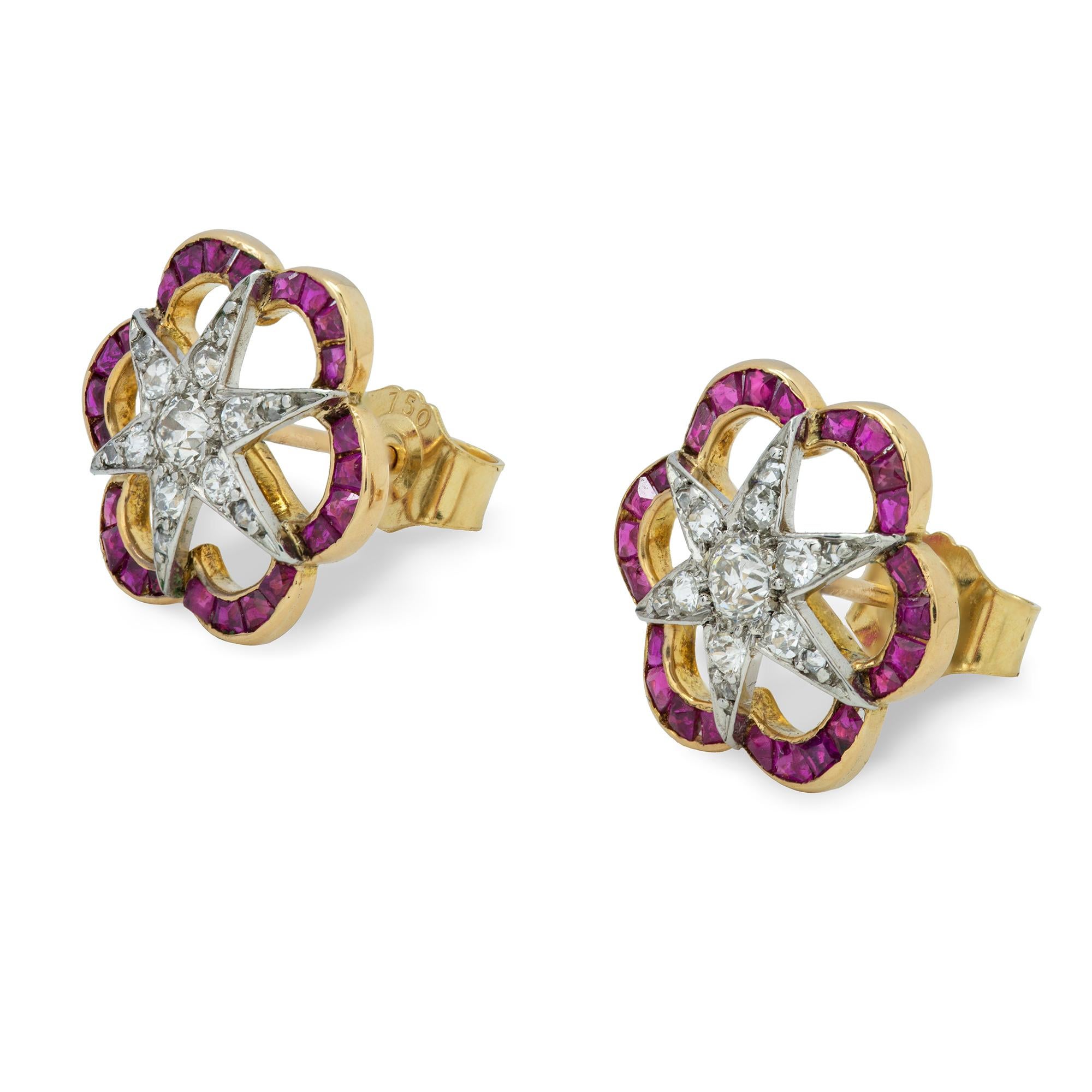A pair of Edwardian diamond and ruby earrings, the central star motif centred with an old brilliant-cut diamond to six radiating arms set with graduated old-cut diamonds, total diamond weight approximately 0.45 carat, within an openwork
