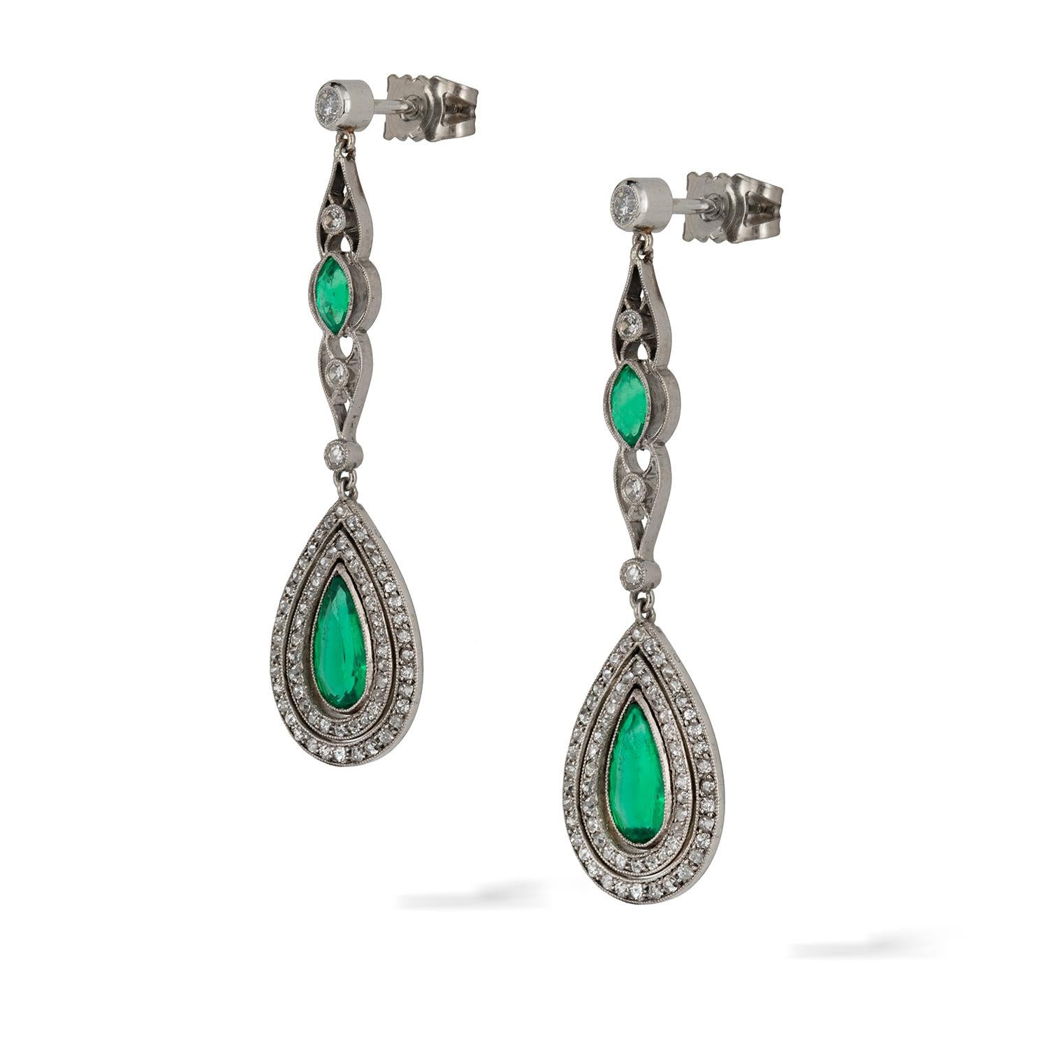 A pair of Edwardian emerald and diamond drop earrings, the pear-shaped emeralds weighing approximately a total of 1.30 carats, accompanied by GCS Report, stating to be of Colombian origin, within articulated concentric border of diamonds