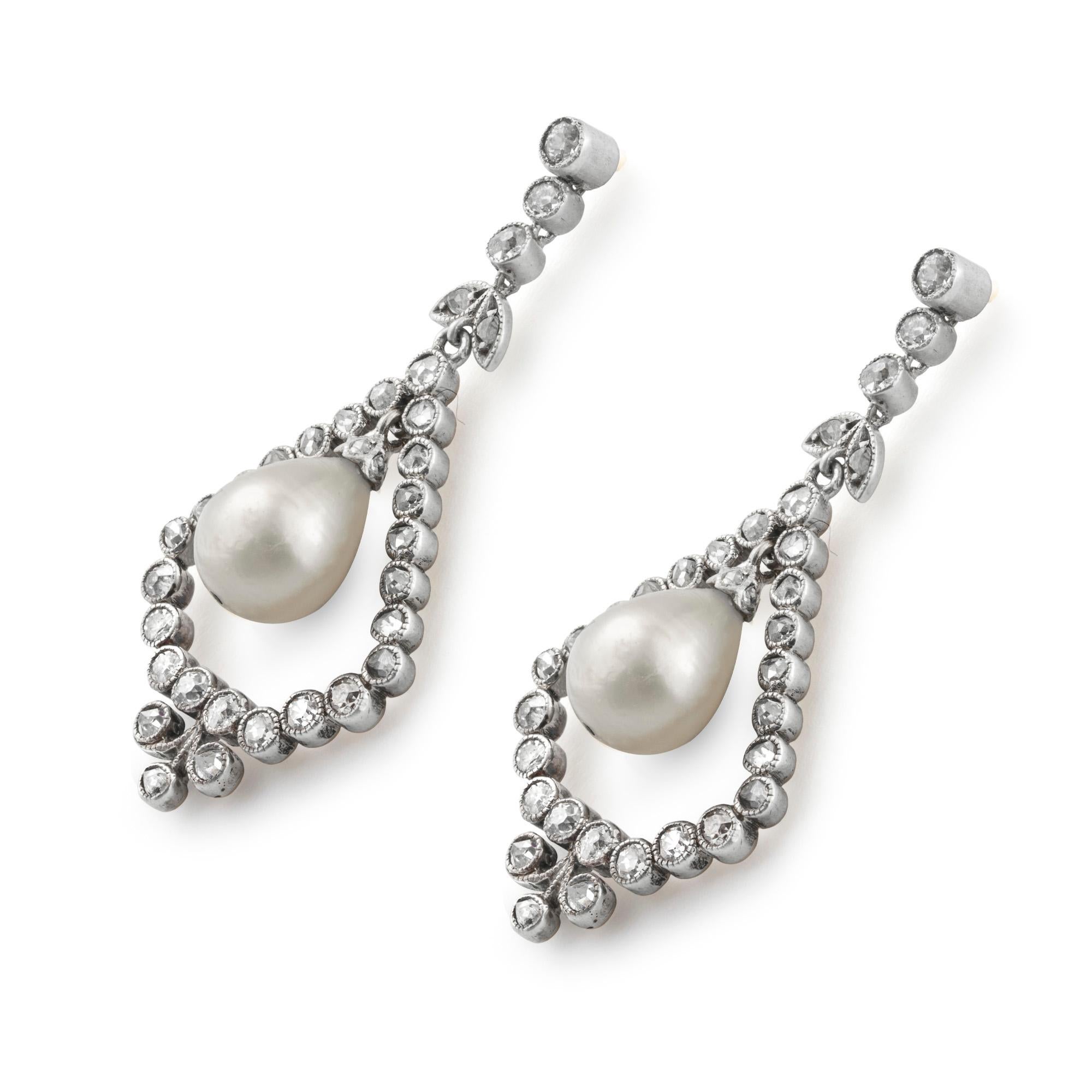 A pair of Edwardian natural pearl and diamond drop earrings, each earring comprising a natural pearl drop, accompanied by GCS report number 5776-5788, stating that the two pearls measure 7.6 - 7.7 x 9.2mm and 7.4 - 7.6 x 9.3mm and are natural
