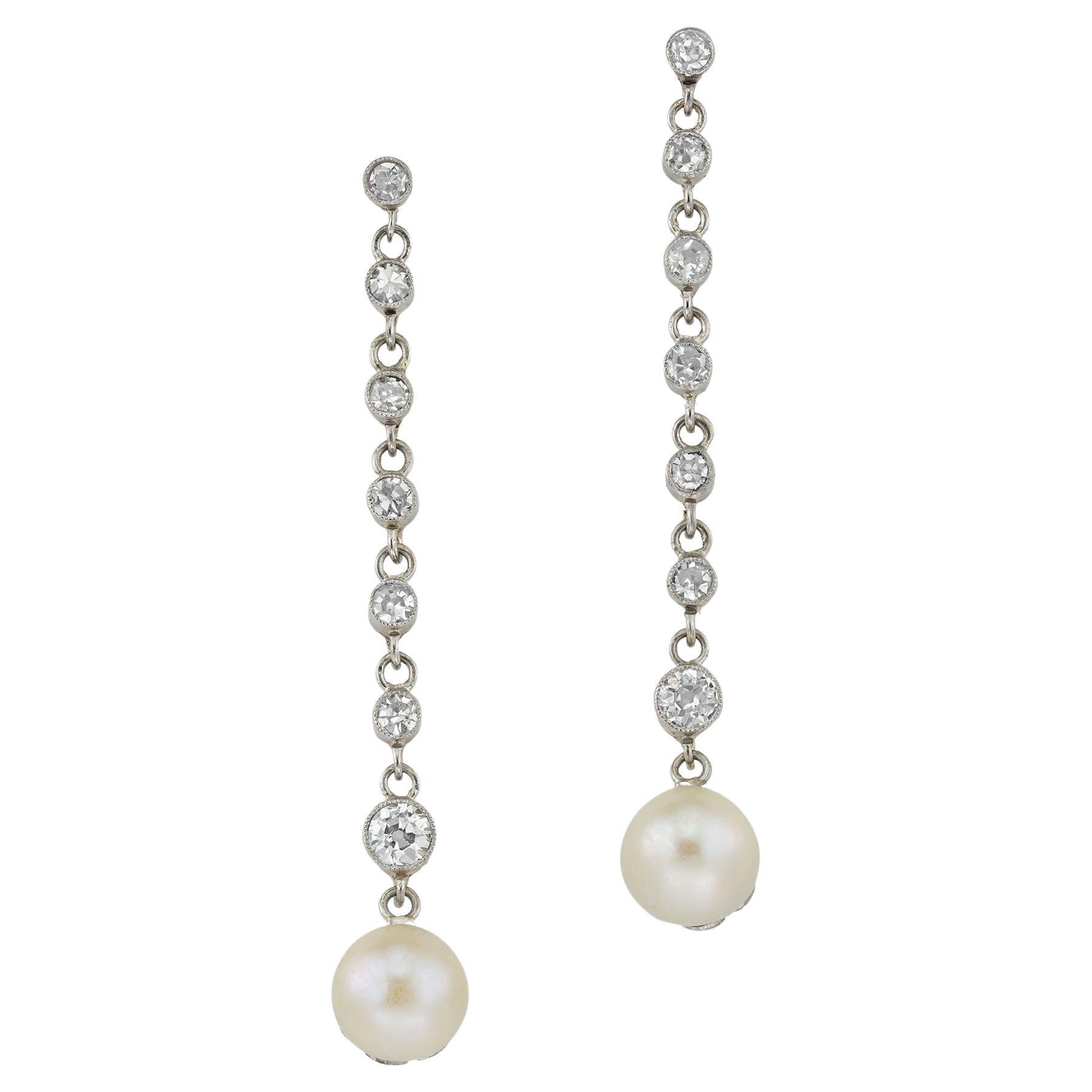 A pair of Edwardian natural pearl and diamond earrings